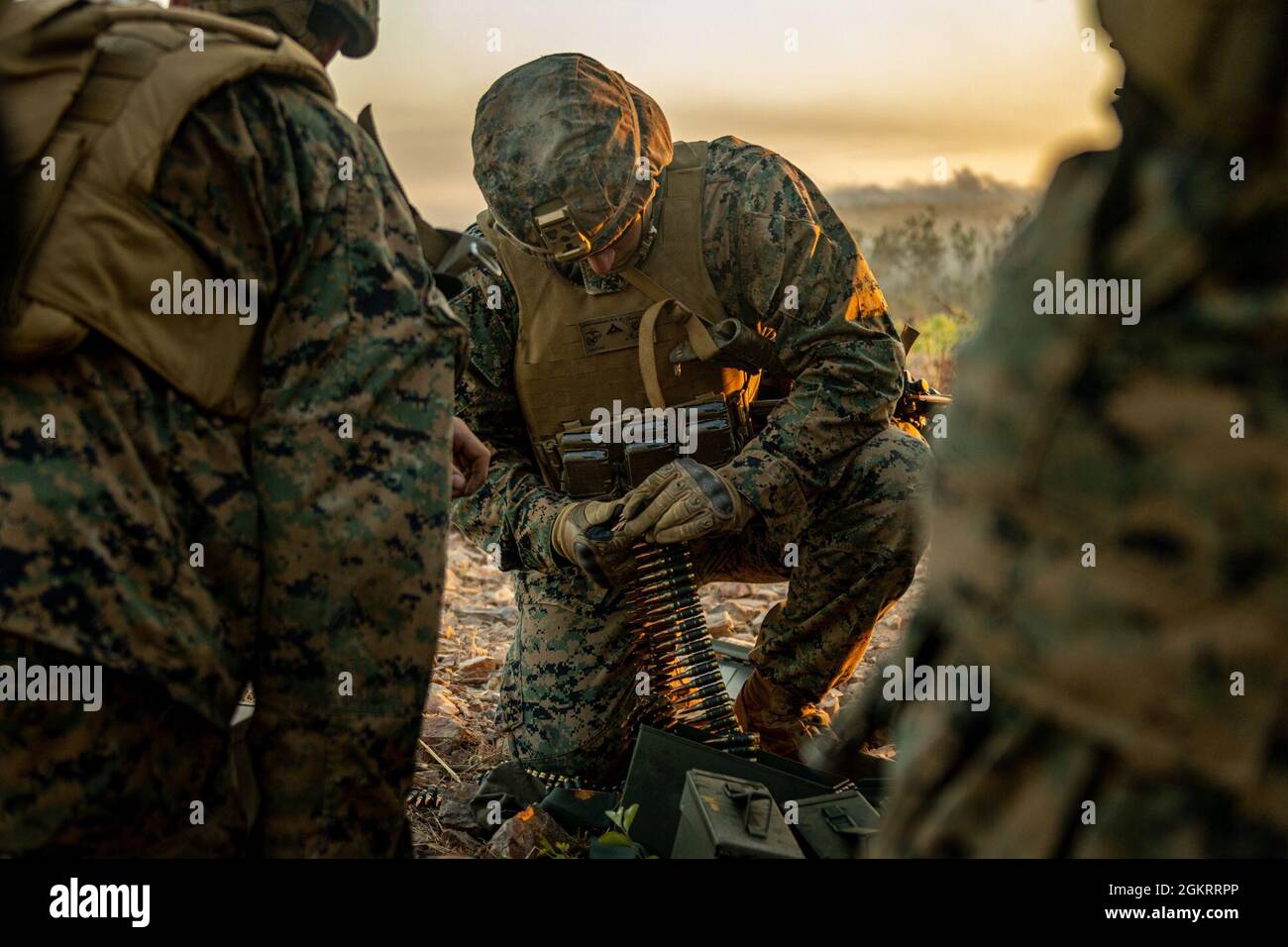 U.S. Marine Corps Lance Cpl. Gavin Montgomery, a machine gunner in Combined Anti-armor Team Blue Platoon, with Weapons Company, 1st Battalion, 7th Marine Regiment (Reinforced), Marine Rotational Force – Darwin, prepares ammunition while participating in support to ground maneuvers training during exercise Southern Jackaroo at Mount Bundey Training Area, NT, Australia, June 23, 2021. The training exercised U.S. Marines’, Australian Army soldiers’ and Japan Ground Self-Defense Force soldiers’ combined capabilities to give mounted and dismounted support to small unit ground maneuvers while utiliz Stock Photo