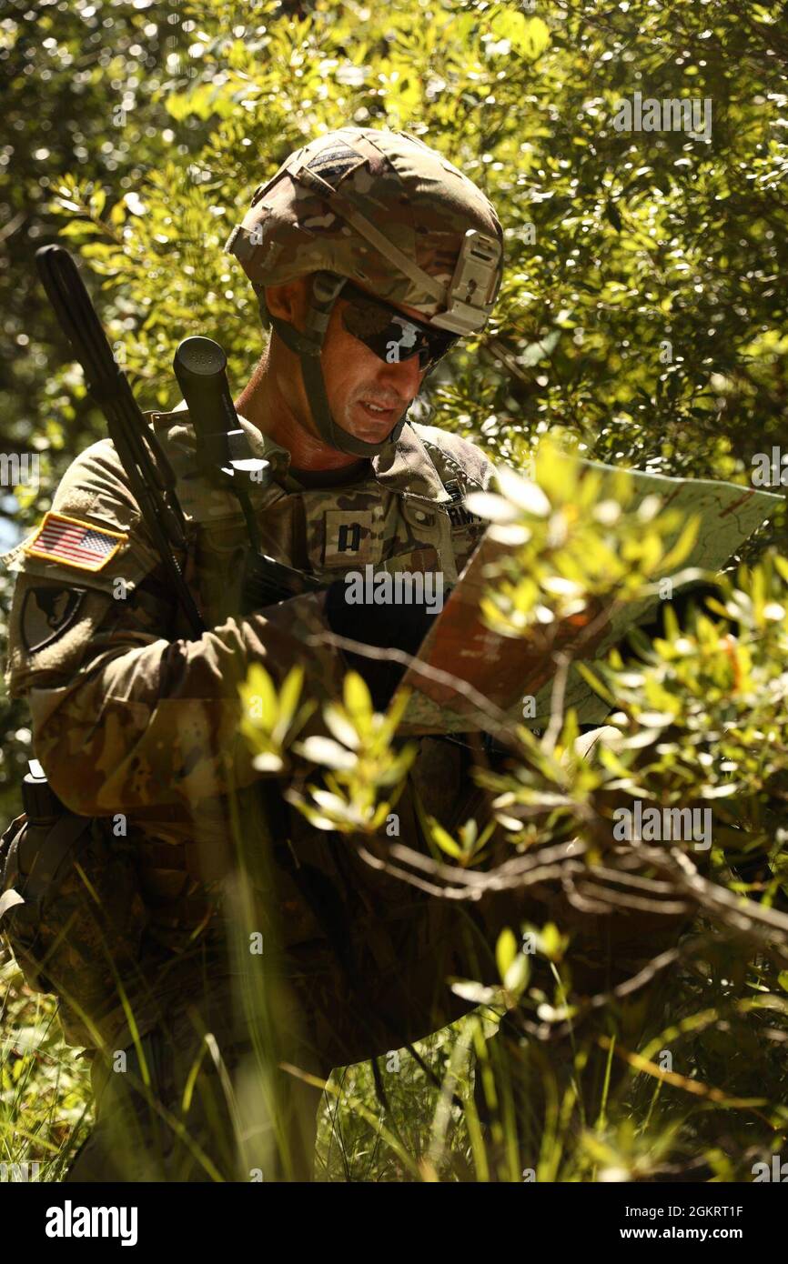 Capt. Joshua Moore, commander of 24th Ordnance Company, 87th Division Sustainment Support Battalion, 3rd Division Sustainment Brigade, determines his unit’s position during a squad-level situational training exercise, at Fort Stewart, Georgia, June 23. 24th Ord. Co. are supporting the 87th DSSB’s Field Training Exercise that consists of tactical operations center exercises, gunnery and convoy operations to prepare the battalion to support logistics missions. Stock Photo