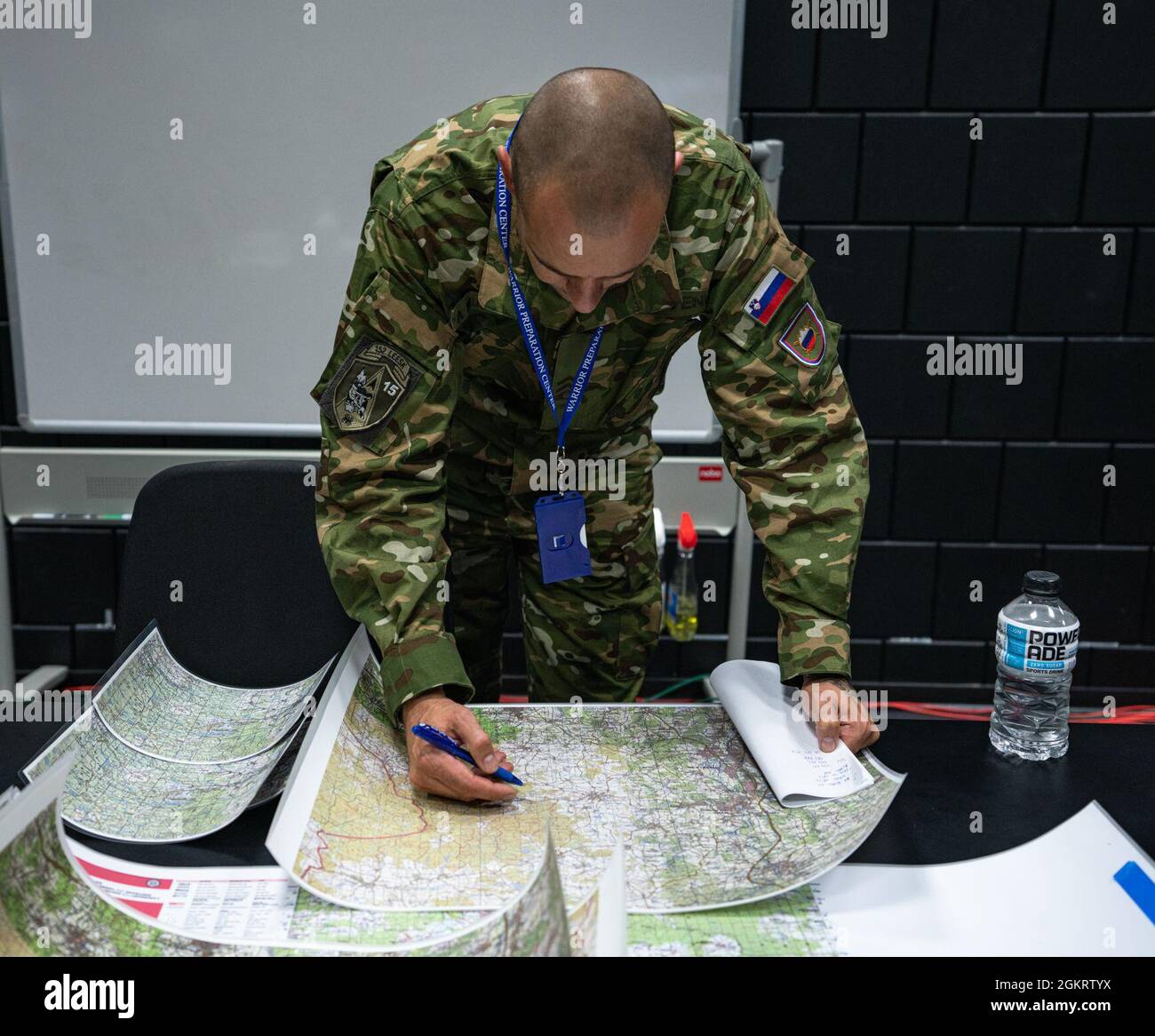 Sergeant 1st Class Almir Mujcinovic, a Joint Terminal Attack Controller with the Slovenian Army’s 152nd Fixed Wing Squadron, annotates locations on a scenario map while attending a 4th Combat Training Squadron course at the U.S. Air Forces in Europe and Air Forces Africa’s Warfare Center on Einsiedlerhof Air Station, Germany, June 23, 2021. “These courses will continue to provide opportunities to improve interoperability between nations,” Mujcinovic said.  The 4th CTS has a multinational team of NATO JTACs with a wide range of experience developing advanced instructor and evaluator courses, a Stock Photo
