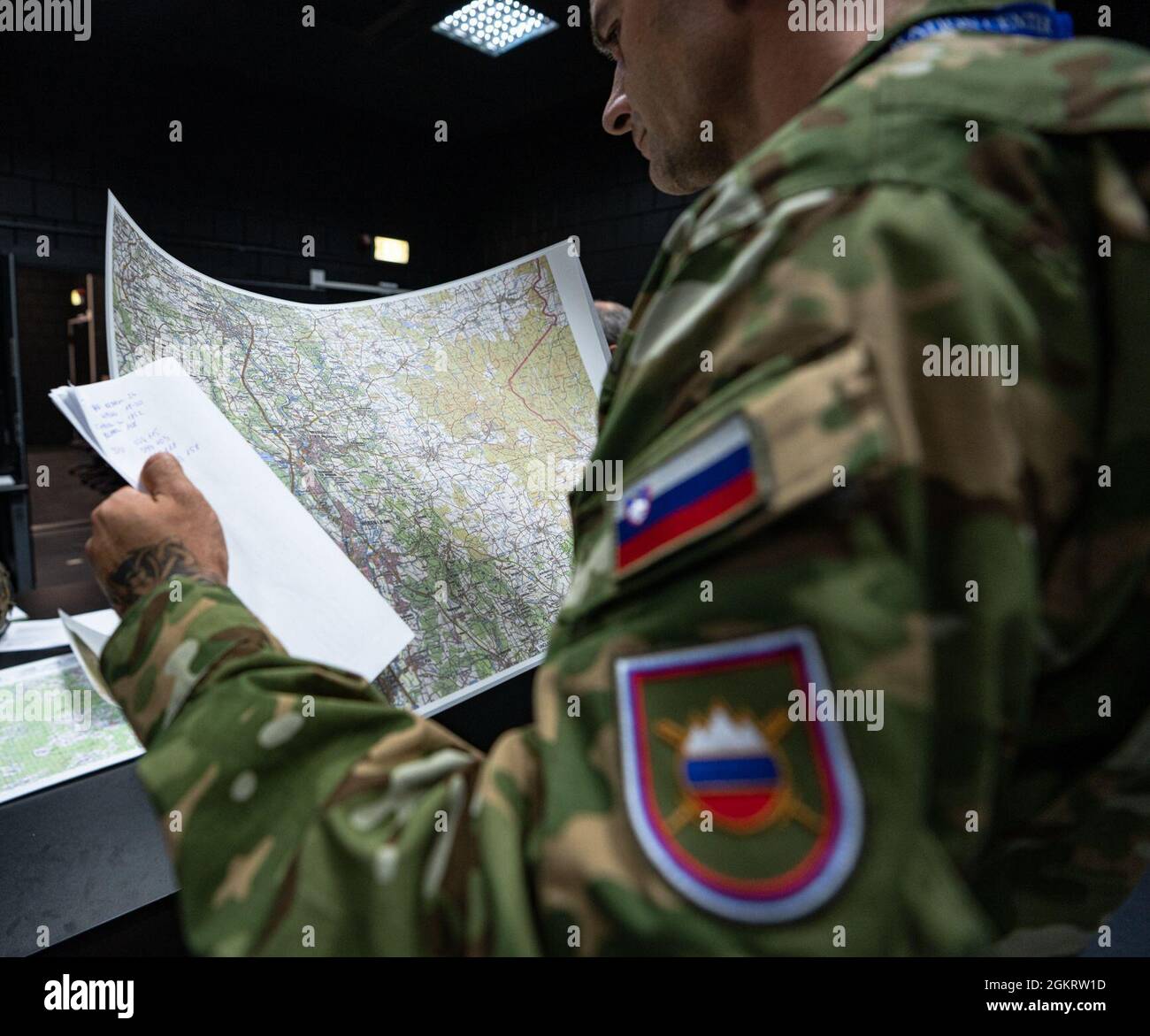 Sergeant 1st Class Almir Mujcinovic, a Joint Terminal Attack Controller with the Slovenian Army’s 152nd Fixed Wing Squadron, reviews scenario maps while attending a JTAC workshop at the U.S. Air Forces in Europe and Air Forces Africa’s Warfare Center on Einsiedlerhof Air Station, Germany, June 23, 2021. Mujcinovic is providing feedback on behalf of the Slovenian Army to the 4th Combat Control Squadron as they develop a multinational JTAC program focused on developing the readiness of the joint warfighter. Stock Photo