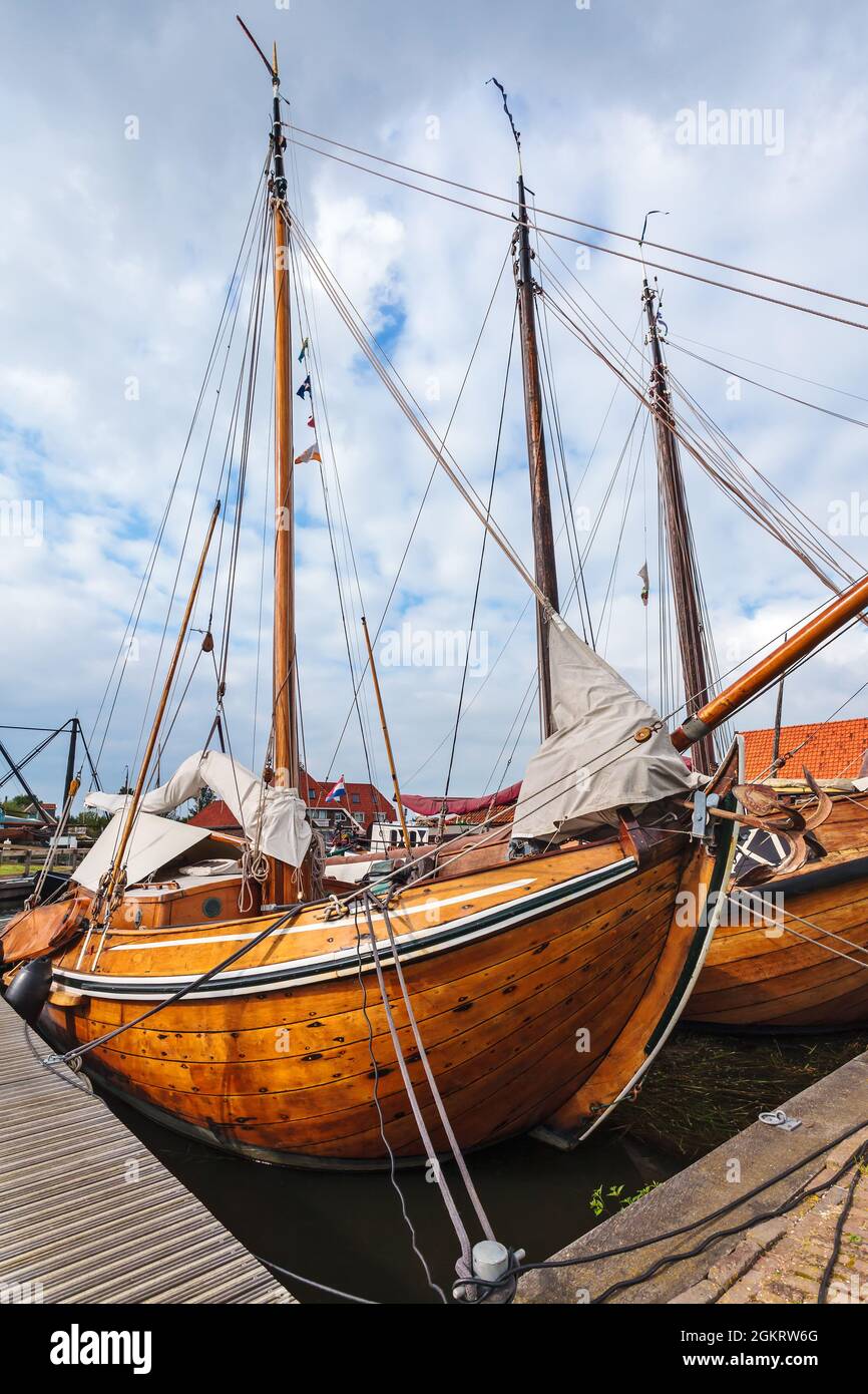 Old wooden sailing boats in the village of Workum in the Dutch province of Friesland Stock Photo