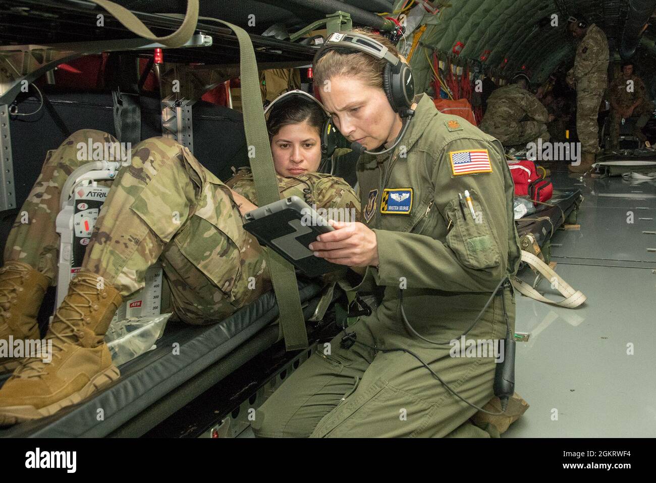 U.S. Air Force Major Kristen George, 459th Aeromedical Evacuation Squadron flight nurse, conducts a patient assessment on 2nd Lt. Rosa kirk, AES flight nurse, during a simulated inn-flight training mission between the 459th AES and 315th AES based out of Charleston, South Carolina. Stock Photo