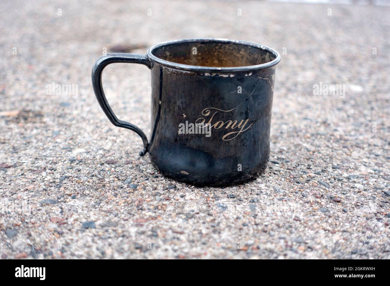 My brother Tony's tarnished silver baby cup with his name on the outside. St Paul Minnesota MN USA Stock Photo