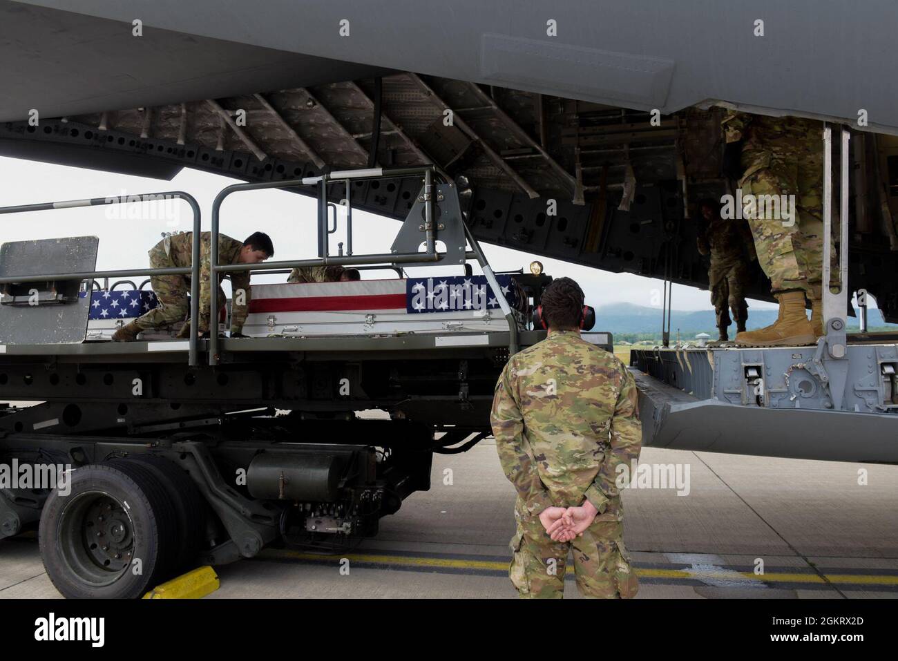 U.S. Air Force Airmen from the 721st Aerial Port Squadron load transport cases containing the possible remains of unidentified World War II soldiers onto a C-17 Globemaster III aircraft at Ramstein Air Base, Germany, June 23, 2021. The remains will undergo examination for possible identification by Defense POW/MIA Accounting Agency forensic anthropologists. The DPAA’s mission is to provide the fullest possible accounting for our missing personnel to their families and the nation. Stock Photo