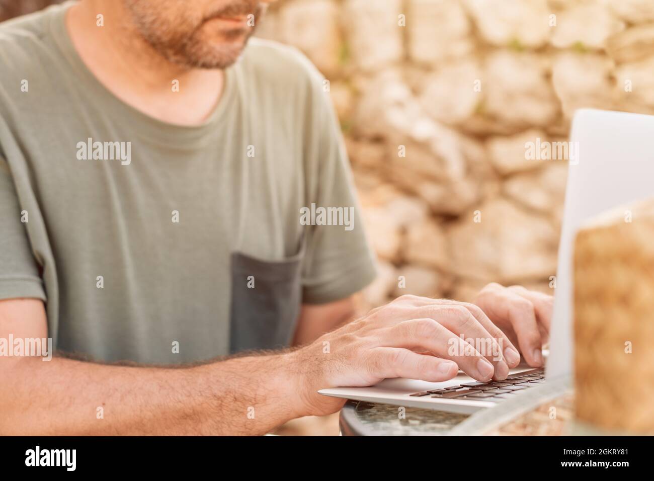 Freelancer and digital nomad working on laptop computer during summer vacation holiday on apartment terrace in morning Stock Photo