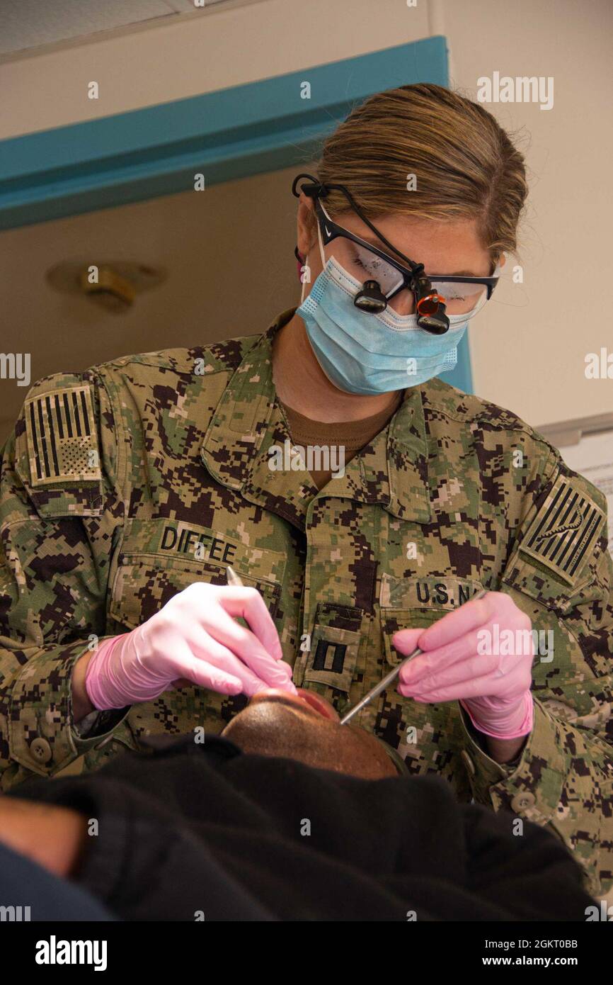 U.S. Navy Lt. Hillary Diffee, the dental division officer, from Stuart, Florida, performs a dental exam on the Floating Accommodation Facility attached to the aircraft carrier USS John C. Stennis, in Newport News, Virginia, June 24, 2021. John C. Stennis is in Newport News Shipyard working alongside NNS, NAVSEA and contractors conducting Refueling and Complex Overhaul as part of the mission to deliver the warship back in the fight, on time and on budget, to resume its duty of defending the United States. Stock Photo