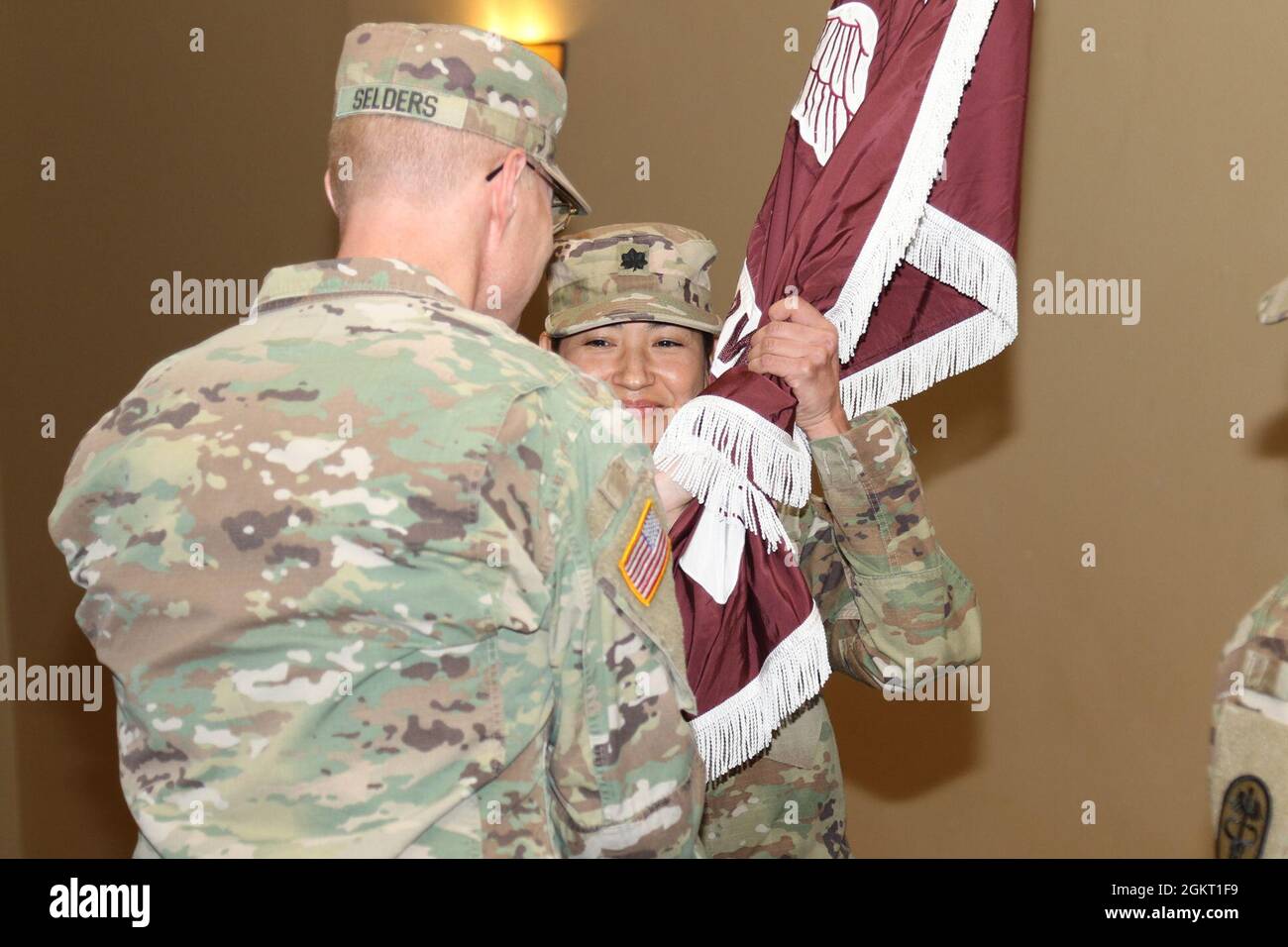 Lt. Col. Leslie Oakes, incoming commander of Fort Irwin Dental Clinic Command, receives the Fort Irwin Dental Clinic Command colors from Col. Robert Selders, Jr., commander of the Fort Carson Dental Health Activity Command, June 24 at Sandy Basin Community Center on Fort Irwin, Calif., signifying her assumption of command. Oakes, an Enterprise, Ala., native, previously served as the chief of pediatric dentistry for Fort Irwin Dental Clinic Command. Stock Photo