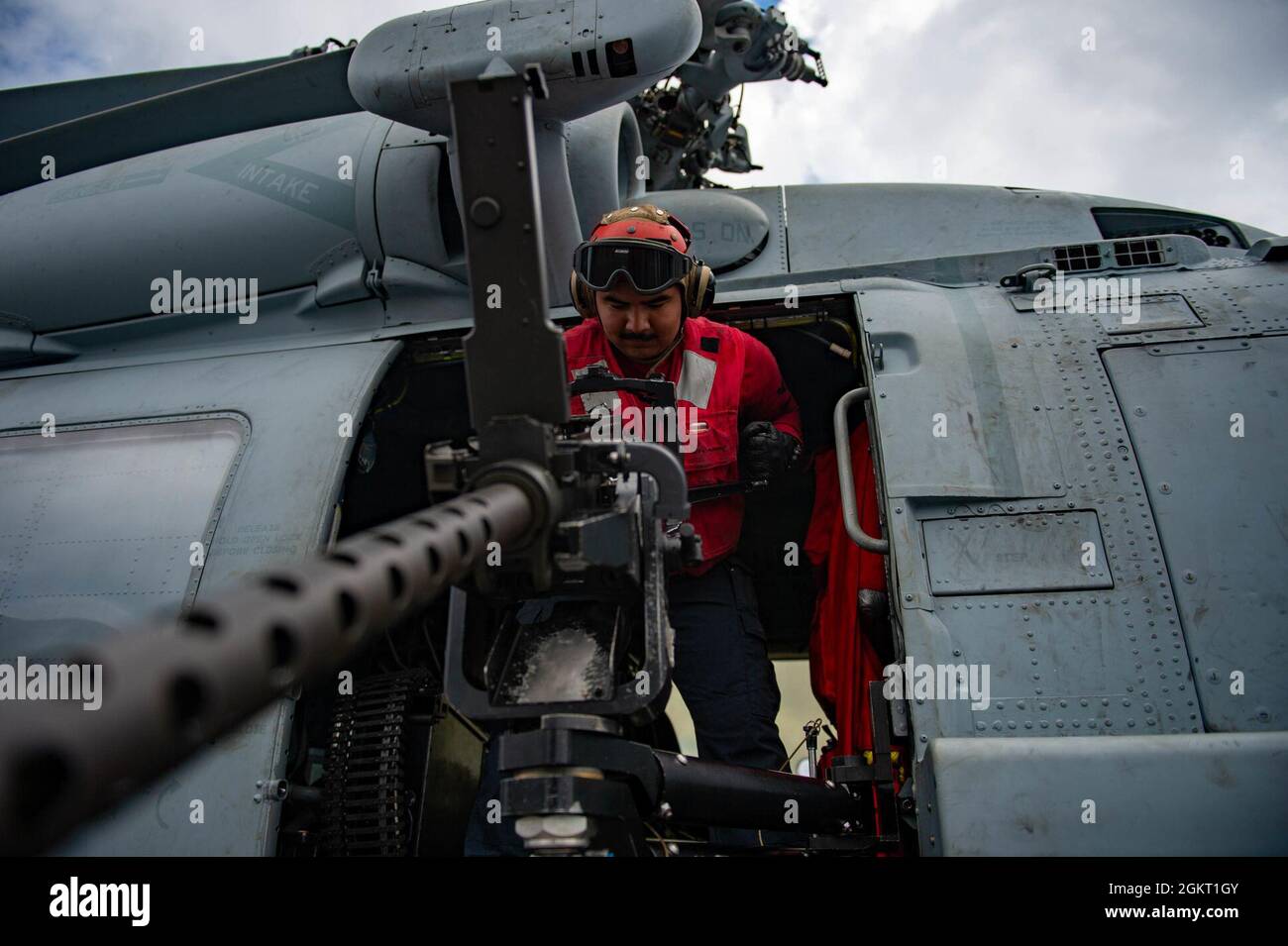 210624-N-NV699-2005 ATLANTIC OCEAN (June 24, 2021) Aviation Ordnanceman 3rd Class Samuel Garcia, from Berwyn, Illinois, prepares a .50-caliber gun mount on an MH-60R Sea Hawk helicopter, attached to the “Proud Warriors” of Helicopter Maritime Strike Squadron (HSM) 72, on the flight deck of the Nimitz-class aircraft carrier USS Harry S. Truman (CVN 75) during Group Sail. Group Sail provides an opportunity for the squadrons and ships of Carrier Strike Group (CSG) 8 to hone their skills and focus on teamwork and communication as they enter the integrated phase of pre-deployment training. Stock Photo