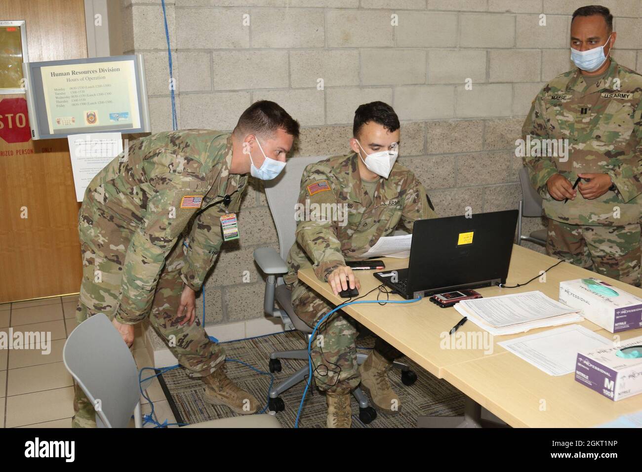 Sgt. Robert Taylor (left), an evacuation noncommissioned officer with 1st Battalion, 144th Field Artillery Regiment of the California Army National Guard, and the emergency manager for Weed Army Community Hospital, assists Pfc. Lane Heis (center), a health care specialist with Weed ACH, with documentation June 24 during a COVID-19 vaccine event at the Dr. Mary E. Walker Center on Fort Irwin, Calif. Taylor, a Tacoma, Wash. Native, served in his civilian and National Guard capacity during the event. Stock Photo