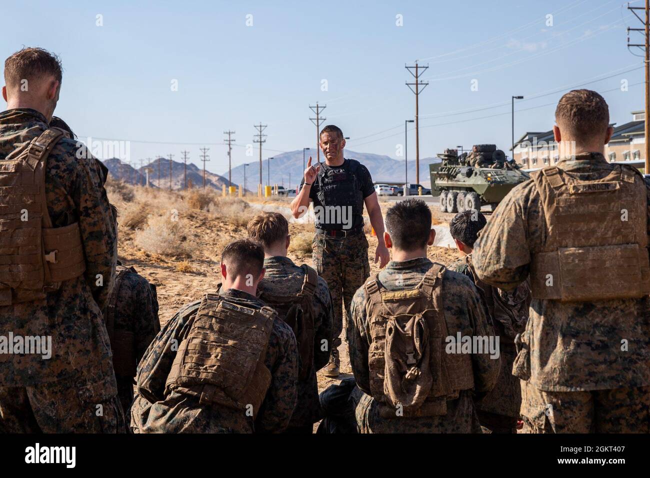 U.S. Marine Corps Staff Sgt. Tyler Thomas, Martial Arts Instructor Trainer, 2nd Battalion, 7th Marine Regiment, 1st Marine Division, conducts a discussion on discipline with U.S. Marines at Marine Corps Martial Arts Instructors Course 2-21 during a culminating training event at Marine Corps Air Ground Combat Center, Twentynine Palms, California, June 24, 2021. MAIC is a 3-week-long training event that qualifies Marines to lead and instruct Marine Corps Martial Arts. Stock Photo