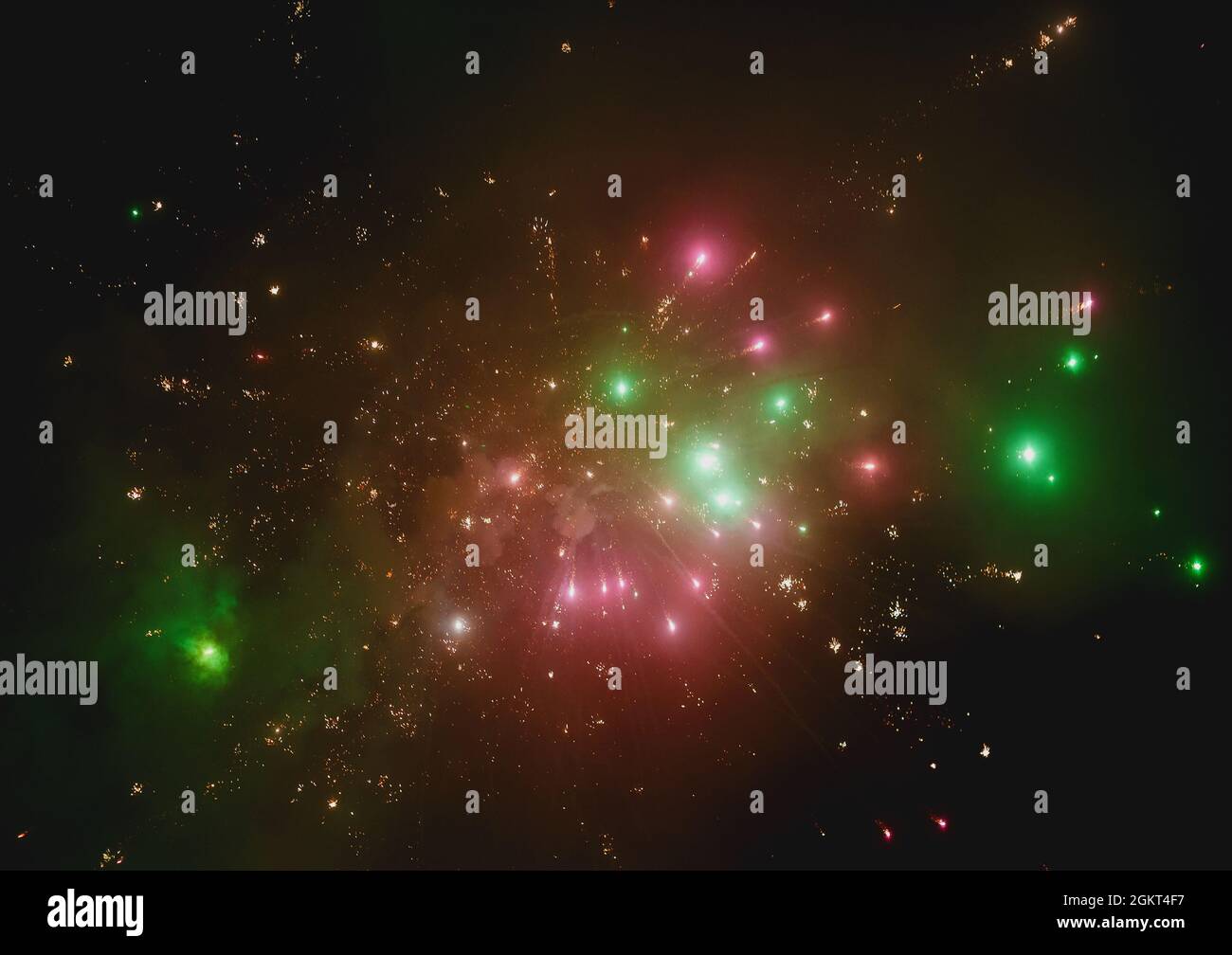 Bright colorful fireworks against the night black sky resembling a galaxy background. Stock Photo
