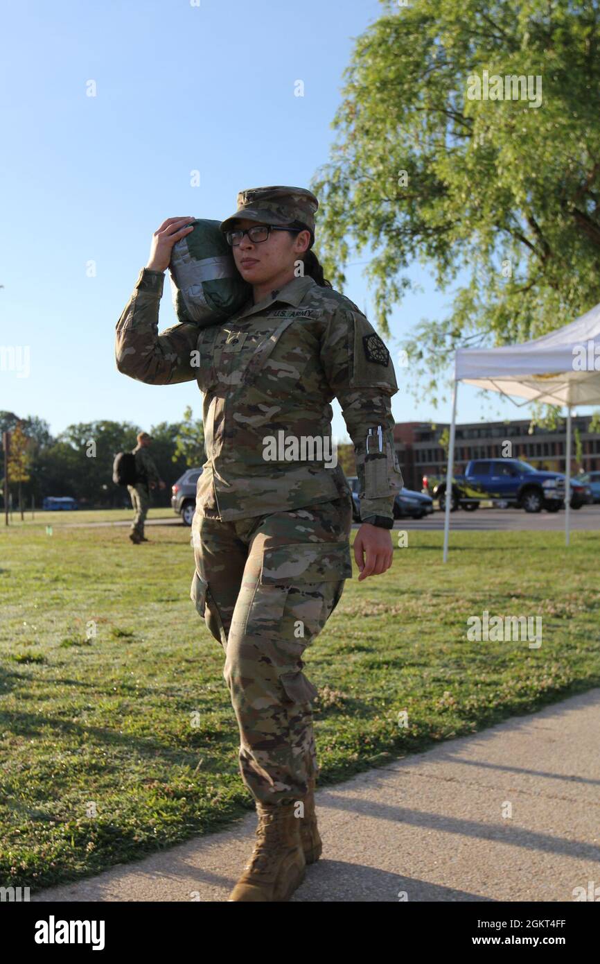 FORT GEORGE G. MEADE, Md. – Spc. Emily Sheets, A Company, 742nd Military Intelligence Battalion, carries a 20-pound sandbag around the parade field in an event the “2021 Tribute to the Fallen” organizers called “Weight of the Fallen,” to express the weight all service members carry following the loss of their fallen comrades. Stock Photo