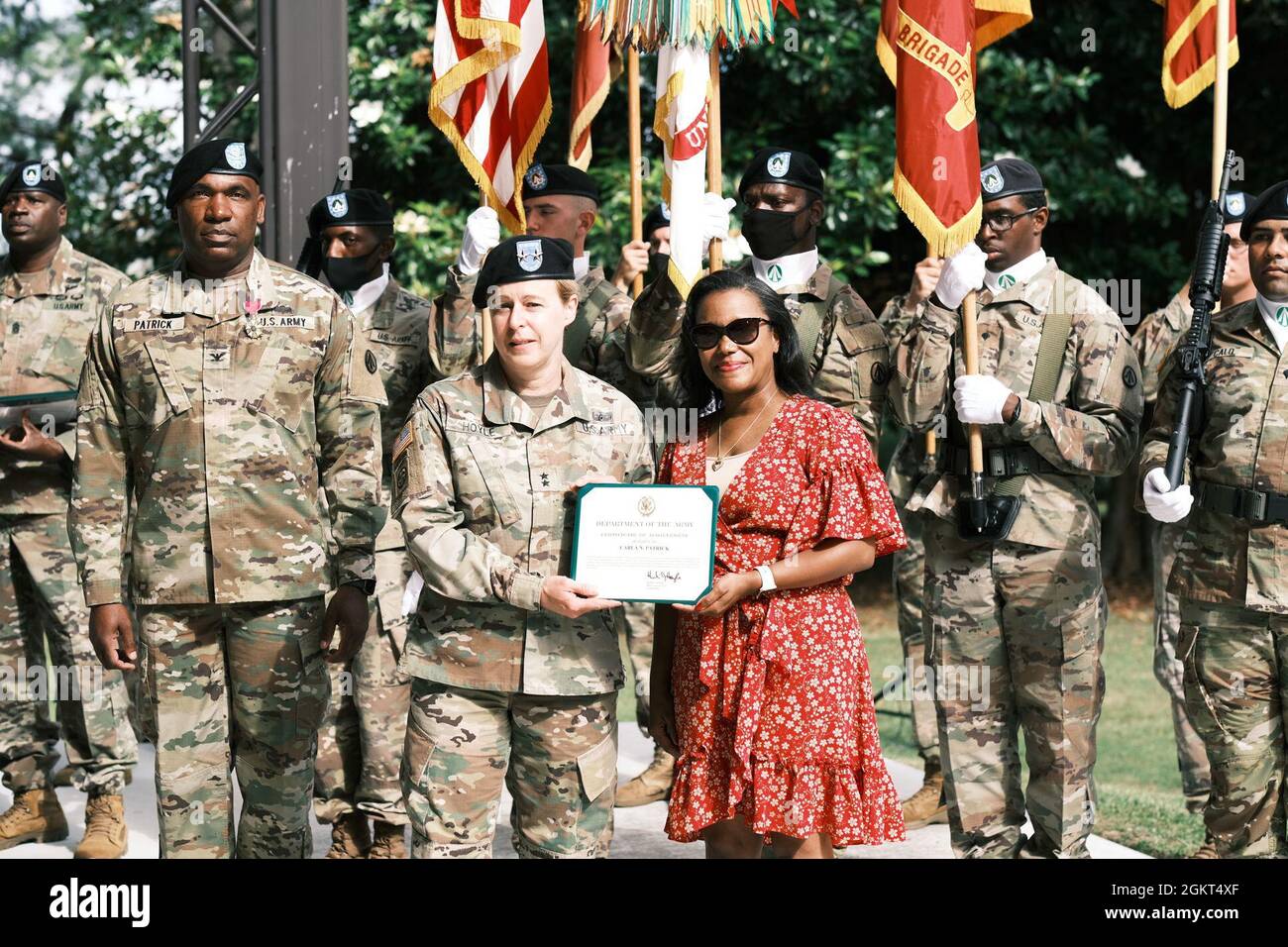 Maj. Gen. Heidi Hoyle, commander, the Military Surface Deployment and Distribution Command, recognized the contributions of Army Families and gave a certificate to Carla Patrick, wife of outgoing 597th Transportation Bde. Commander Col. Michael Patrick, during a Change of Command Ceremony at Magnolia Park, Fort Eustis, Va. June 25. Stock Photo