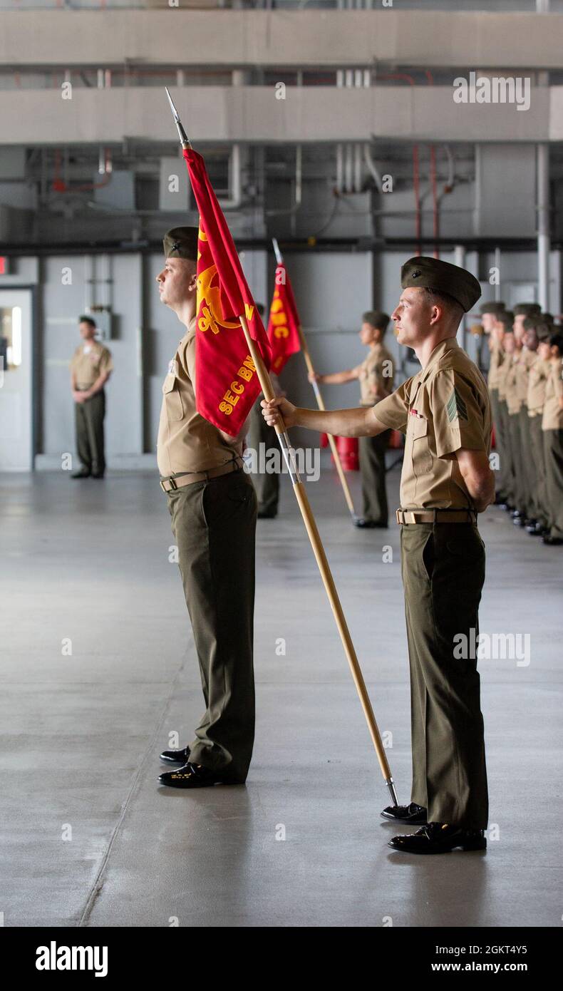 Marines participating in the ceremony stand at parade rest during the Security Battalion’s change of command ceremony at Marine Corps Base Quantico, Virginia, June 25, 2021. Lt. Col. John L. Roach, Security Battalion’s commanding officer, relinquishes all duties and responsibilities over to Lt. Col. David S. Rainey.  Roach has been with Security Battalion since June 2019 and now departs June 2021. Stock Photo