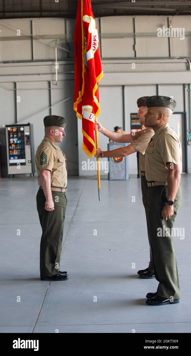 U.S. Marine Corps 1st Sgt. Kristopher Privitar, Security Battalion’s sergeant major, passes the colors to Lt. Col. John L. Roach, Security Battalion’s commanding officer during the Security Battalion’s change of command ceremony at Marine Corps Base Quantico, Virginia. June 25, 2021. Lt. Col. John L. Roach, Security Battalion’s commanding officer, relinquishes all duties and responsibilities over to Lt. Col. David S. Rainey.  Roach has been with Security Battalion since June 2019 and now departs June 2021. Stock Photo