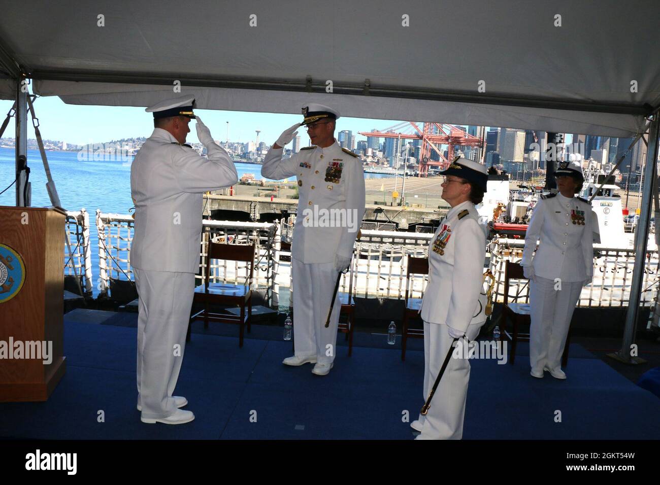 Coast Guard Rear Adm. Peter W. Gautier, acting commander, U.S. Coast Guard Pacific Area and Defense Forces West, salutes Capt. Kenneth J. Boda during the Coast Guard Cutter Healy (WAGB 20) change of command ceremony aboard the cutter moored at Base Seattle, June 25, 2021. Boda relieved Capt. Mary Ellen J. Durley as Healy’s commanding officer during the ceremony. Stock Photo