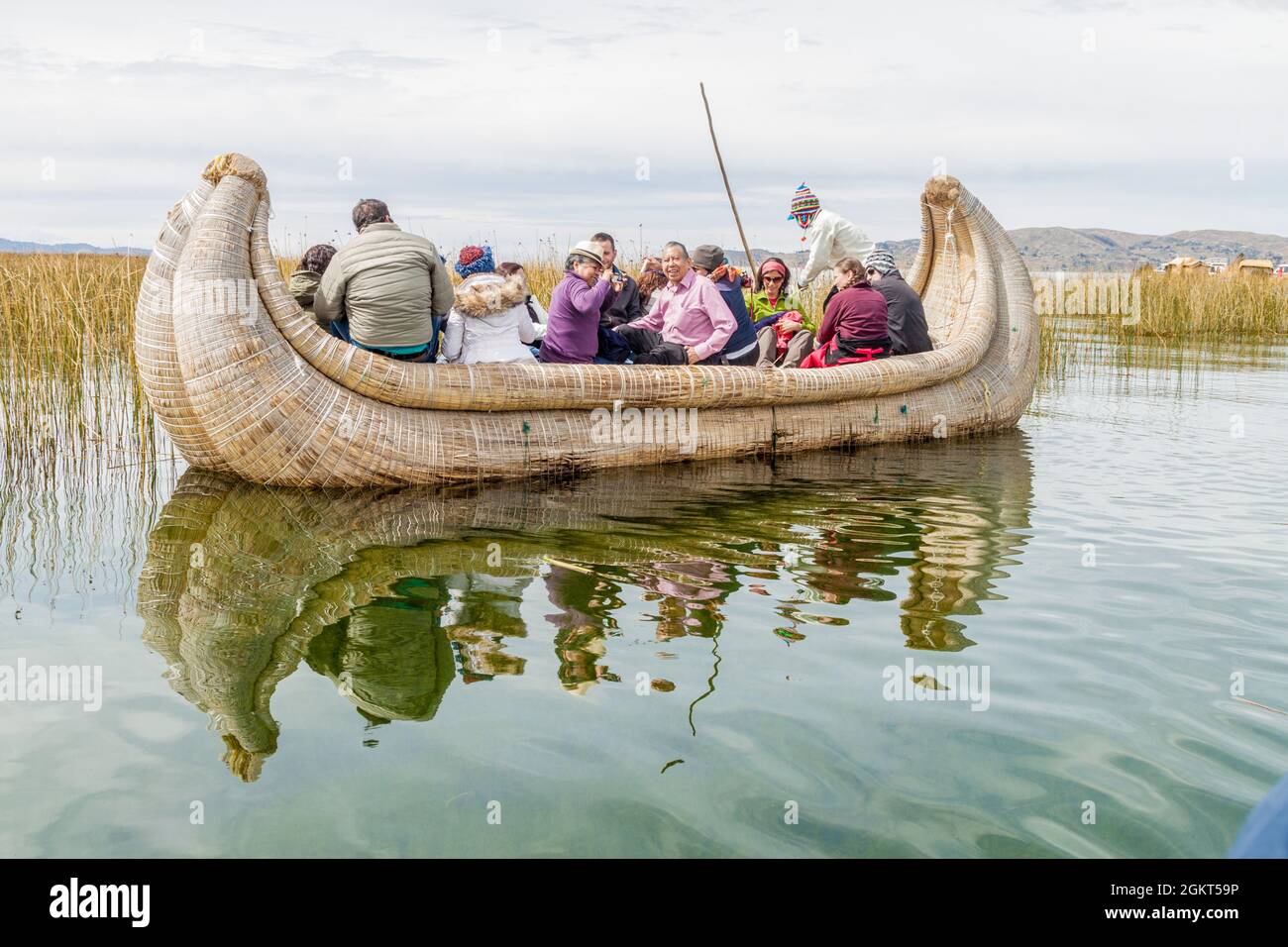Titicaca Reed Raft TITICACA, PERU - MAY 15, 2015: Visitors on a reed boat near Uros ...