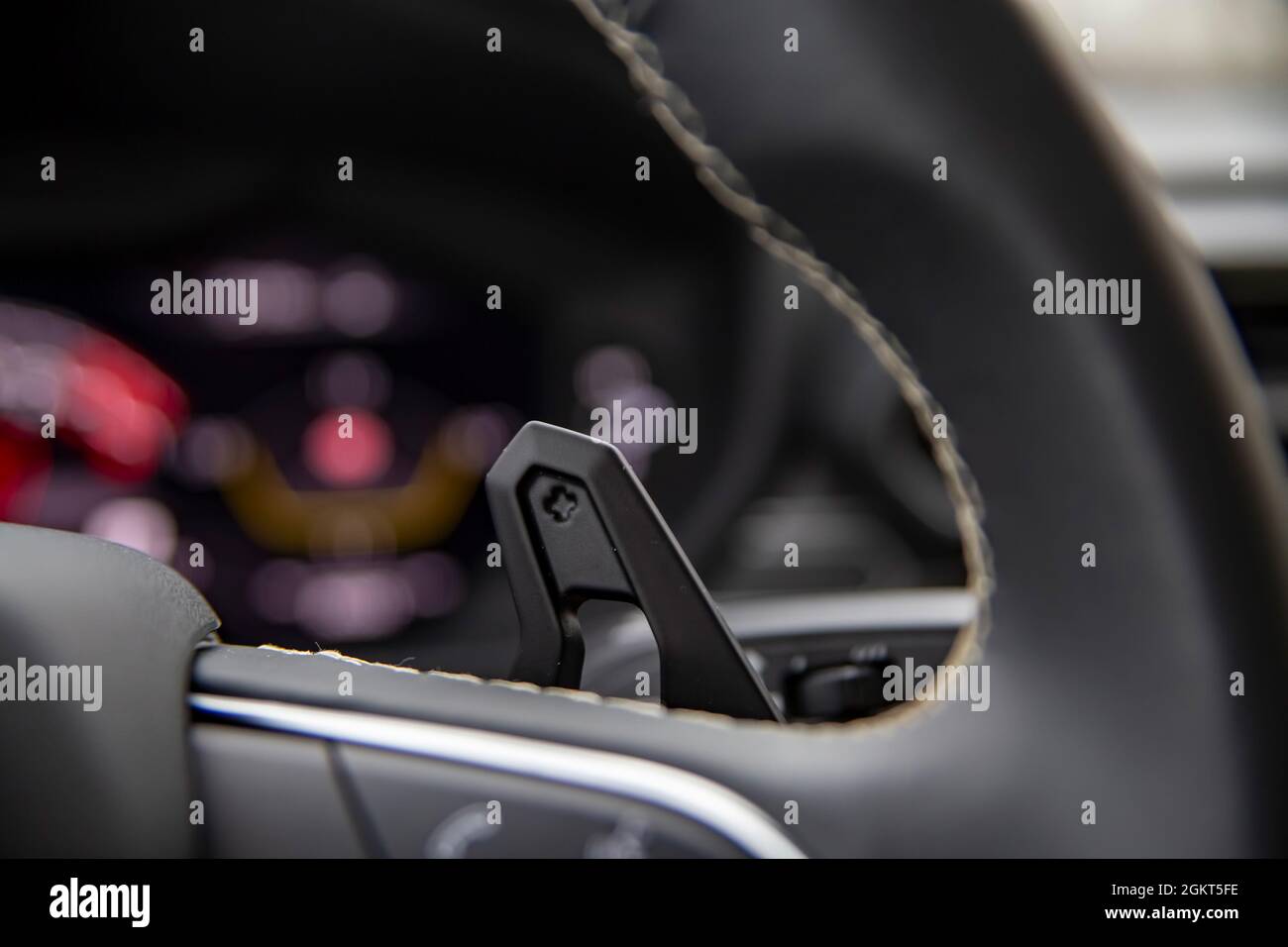 close up of paddle shifter on steering wheel in a modern premium car.Speedshift manual gear