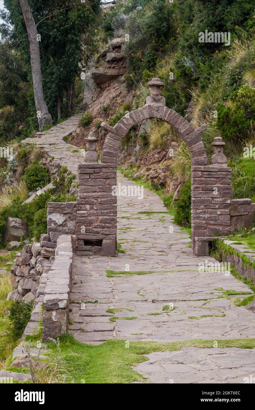 Path through a gate on Taquile island in Titicaca lake, Peru Stock Photo