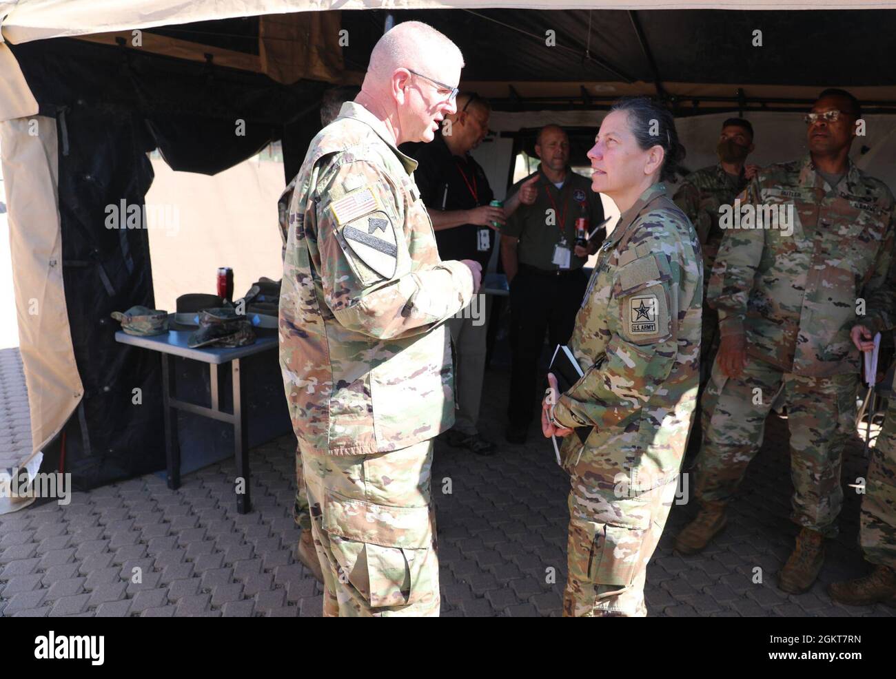 Brig. Gen. Gen. Jeffrey C. Coggin (left), commanding general of the U.S. Army Civil Affairs and Psychological Operations Command (Airborne), speaks with Lt. Gen. Jody J. Daniels (right), chief of Army Reserve and commanding general, U.S. Army Reserve Command, as they participate in the Joint Warfighting Assessment 2021 distinguished visitor day initial briefing at Fort Carson, Colo., June 25, 2021. U.S. Army Civil Affairs and Psychological Operations Command (Airborne) Civil Affairs, Psychological Operations, and Information Operations Soldiers took part in JWA 2021 with participants from diff Stock Photo