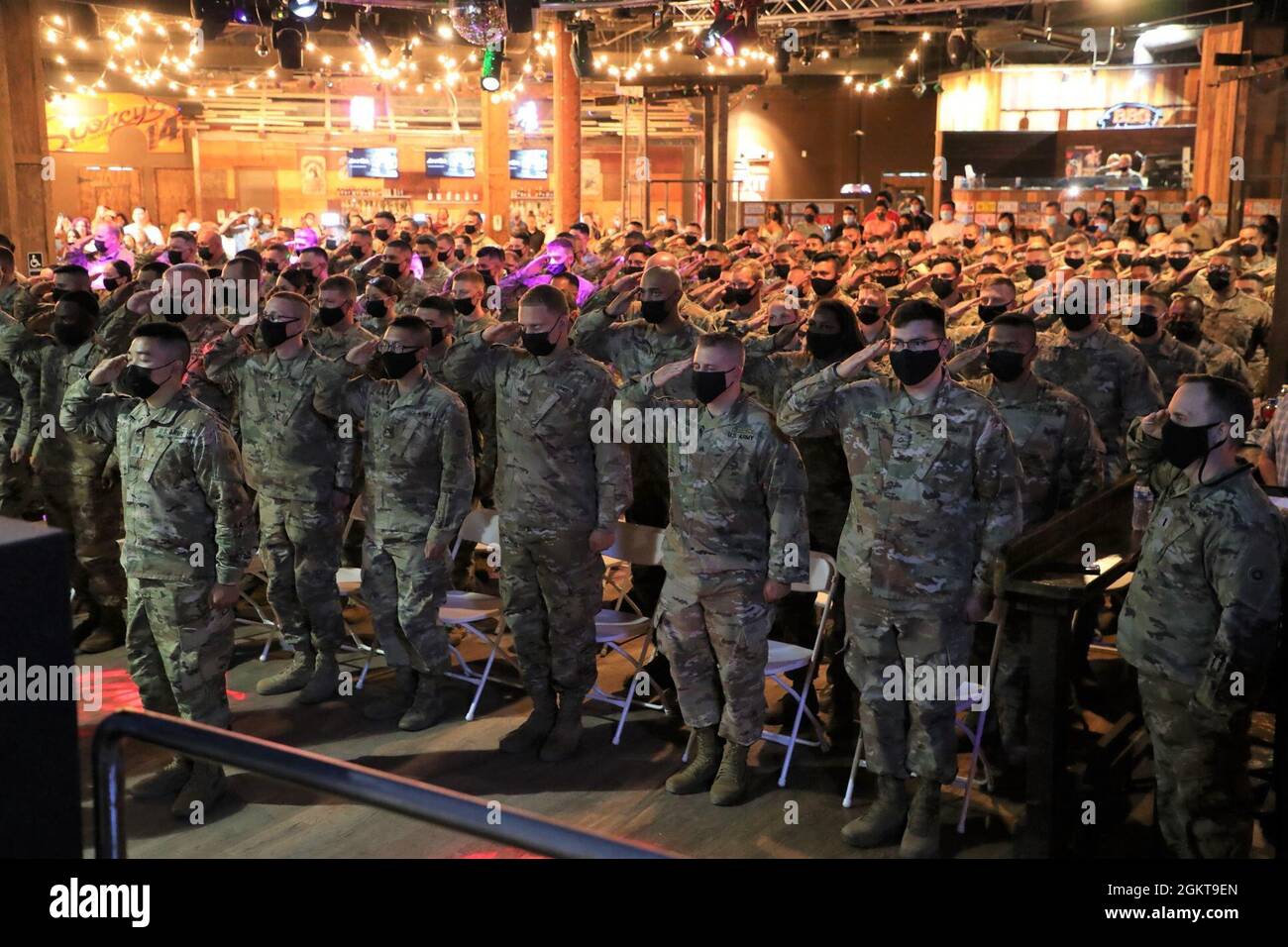 Soldiers salute the colors during the 645th ICTC deployment ceremony and send-off celebration at Stoney's Rockin' Country in Las Vegas, Nev. on June 26, 2021. Stock Photo