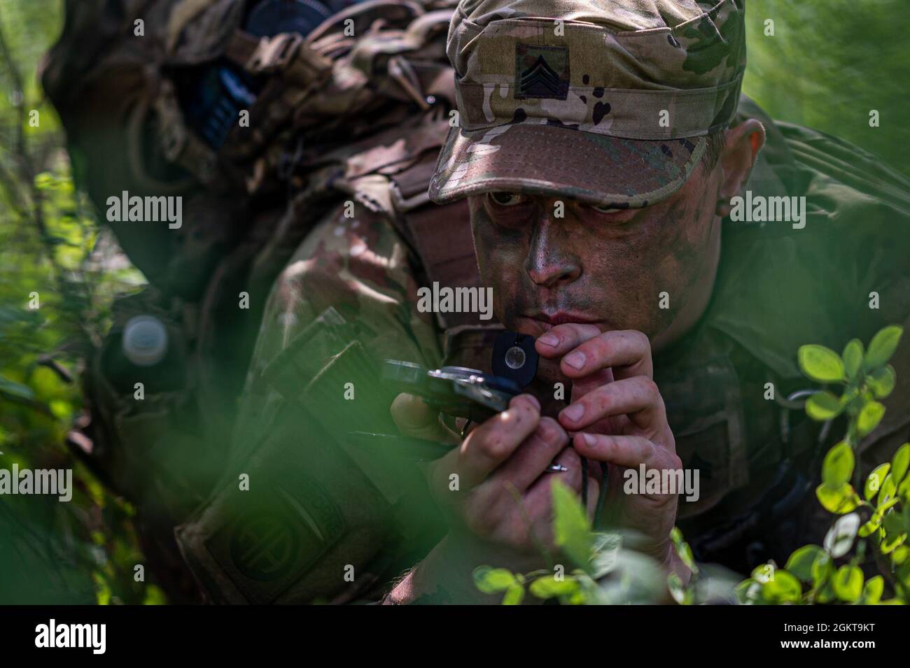 Soldier Using Compass U.S. Army Soldiers uses a compass during a situational training ...