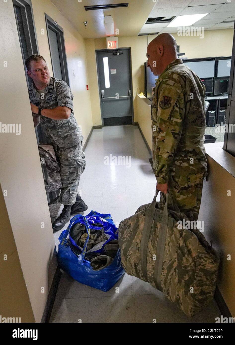 688th Cyberspace Wing Command Chief Master Sgt. Jeffrey Glawe carries  donated ABUs to the Civil Air Patrol cadet squadron supply room, June 28.  2021 at Port San Antonio, San Antonio, Texas. The