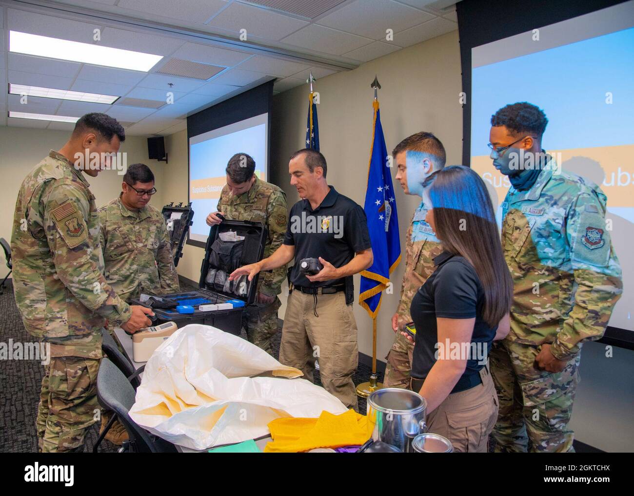 Special agents from the Federal Bureau of Investigations (FBI) and Airmen from the 6th Air Refueling Wing inspect hazardous material (HAZMAT) gear at MacDill Air Force Base, Florida, June 28, 2021. The FBI conducted a weapons of mass destruction and HAZMAT crime scene training in order to further advance its partnership with MacDill and to keep the surrounding community safe. Stock Photo