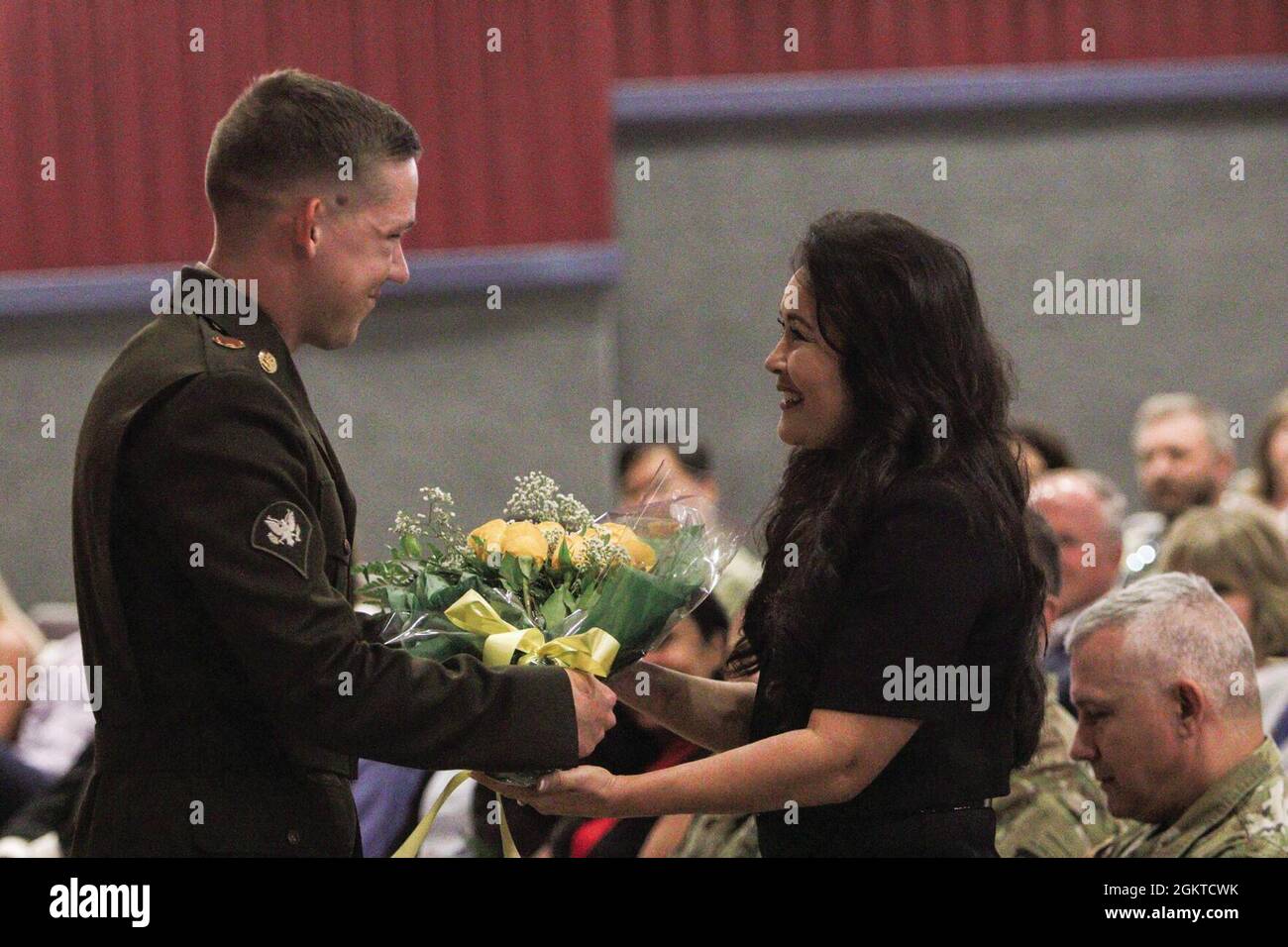Specialist Alexander Hayden, Headquarters and Headquarters Company, U.S. Army Garrison-Fort Campbell, presents a bouquet of flowers to Susan Jordan June 28 during the garrison change of command ceremony at Wilson Theater. Susan’s husband, Col. Andrew Q. Jordan, incoming Fort Campbell garrison commander, assumed command of the garrison during the ceremony. Stock Photo
