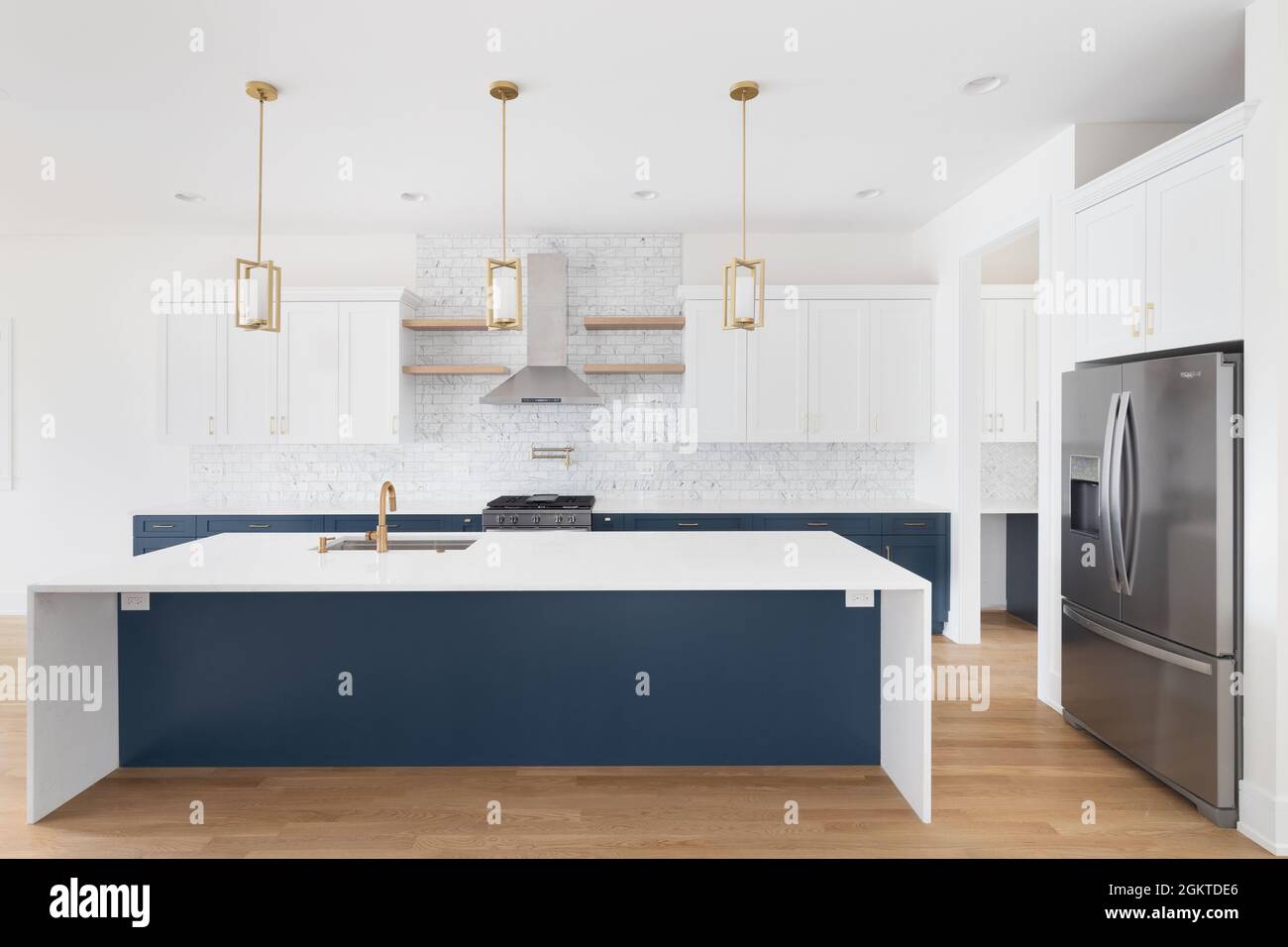 A luxurious white and blue kitchen with gold hardware, Bosch and Samsung  stainless steel appliances, and white marbled granite counter tops Stock  Photo - Alamy