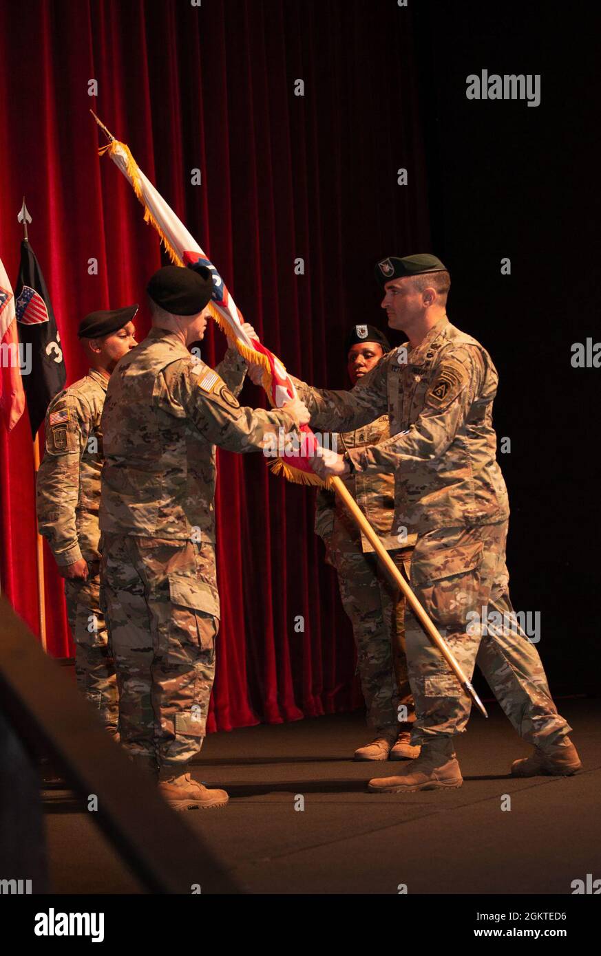 Lt. Col. Richard P. Teta, right, U.S. Army North Headquarters and  Headquarters Battalion commander, passes the colors to incoming Command  Sgt. Maj. Scotty L. Messer (left), during the HHBN change of responsibility