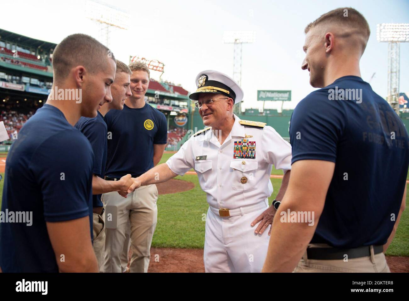 210629-N-BB269-1068 (June 29, 2021) Chief of Naval Operations Adm. Mike Gilday congratulates newly-enlisted Navy Sailors prior to a Red Sox baseball game at Fenway Park, Boston. Prior to the game, CNO administered the oath of enlistment to future U.S. Navy Sailors, Strike Fighter Squadron 213 (VFA-213) the Blacklions conducted a fly over, a Navy Band D.C. vocalist sang the national anthem, and the USS Constitution color guard paraded the colors in front of the audience. Stock Photo