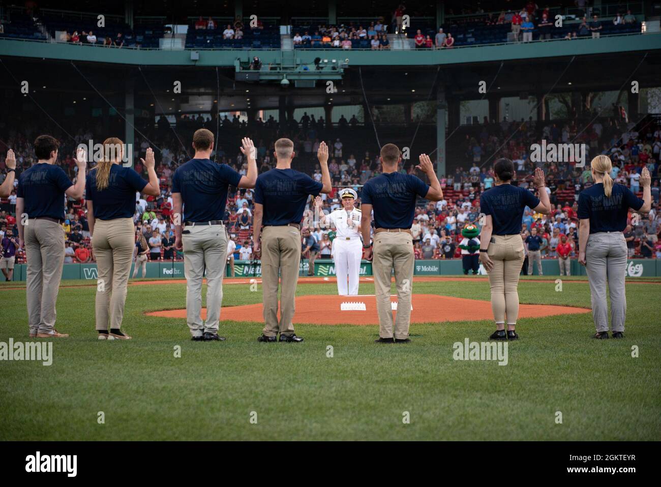 210629-N-BB269-1196 (June 30, 2021) Chief of Naval Operations Adm. Mike Gilday administers the oath of enlistment to future U.S. Navy Sailors prior to a Red Sox baseball game at Fenway Park, Boston. The celebration of military service included Strike Fighter Squadron 213 (VFA-213) the Blacklions conducted a fly over, a Navy Band D.C. vocalist sang the national anthem, and the USS Constitution color guard paraded the colors in front of the audience. Stock Photo