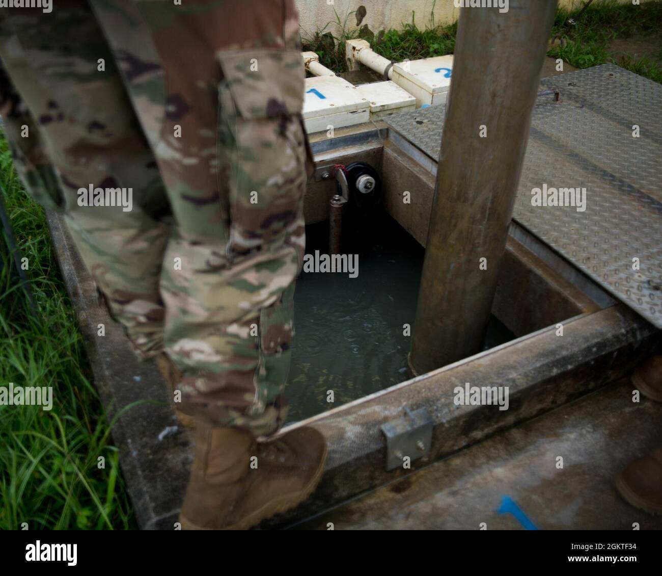 A U.S. Air Force 18th Civil Engineer Squadron Water and Fuel Systems Maintenance technician evacuates excess water from a sewage system overtaxed by heavy rainfall into a mobile system on Kadena Air Base, Japan, June 29, 2021. A WFSM technician’s duties range from treating water to ensure it's safe to drink, to maintaining the aircraft’s fueling systems that keep jets in the air. Stock Photo