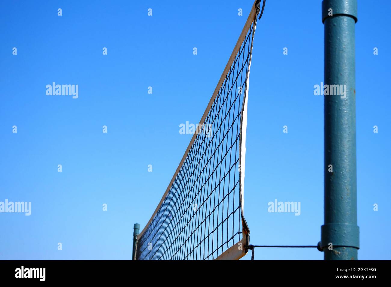 Volleyball net against blue sky. Beach volleyball equipment. Copy space. Stock Photo
