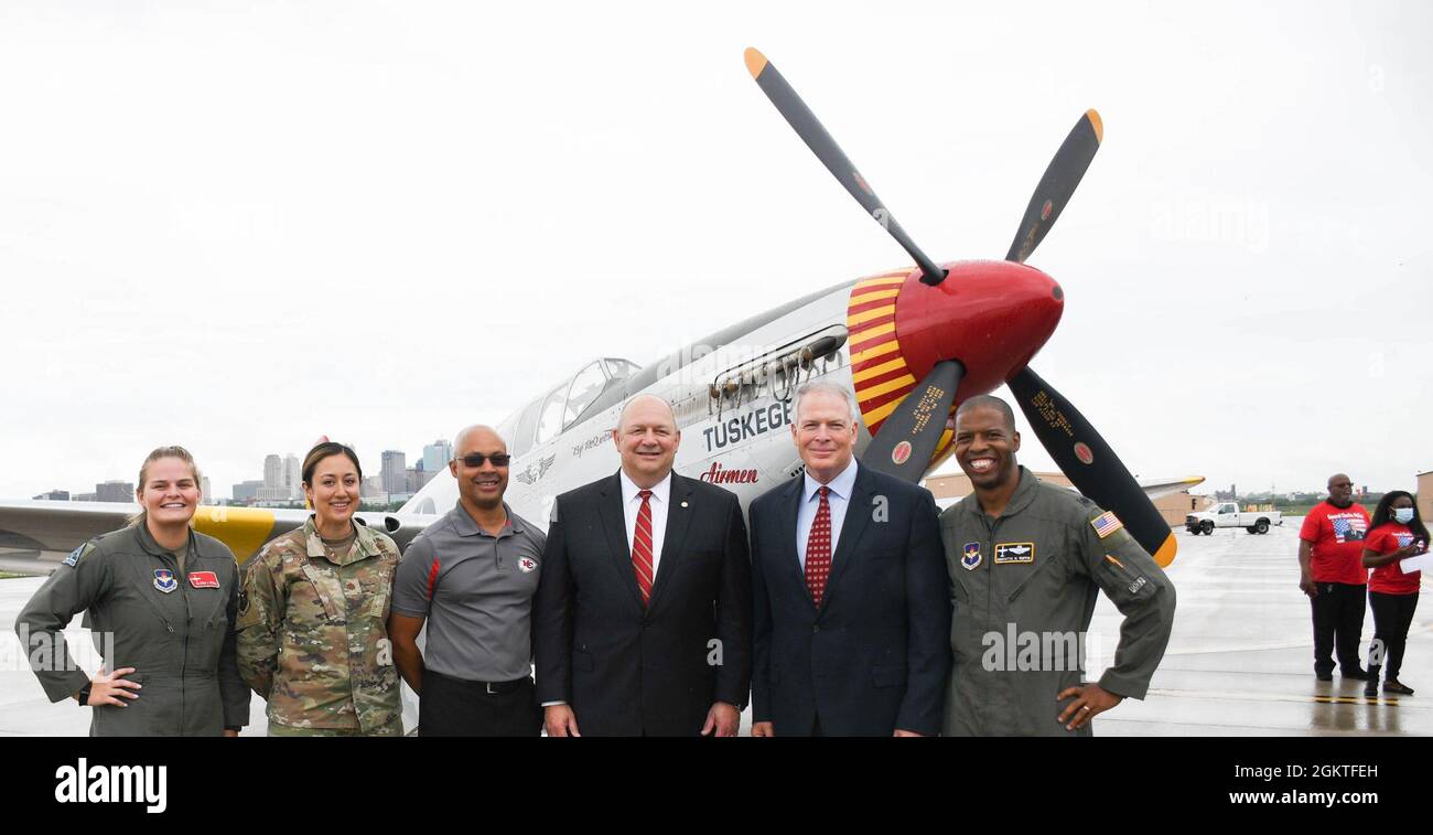 U.S. Air Force Academy graduates who attended or spoke at the day’s ceremony pose for a photo near a Red-Tail P-51 Mustang painted to honor the Tuskegee Airmen June 29, 2021, outside the Charles E. McGee General Aviation Terminal at Charles B. Wheeler Downtown Airport in Kansas City, Mo. McGee, the terminal’s namesake, flew more than 100 combat missions in World War II, escorting U.S. bombers to and from targets in Axis territory. Stock Photo