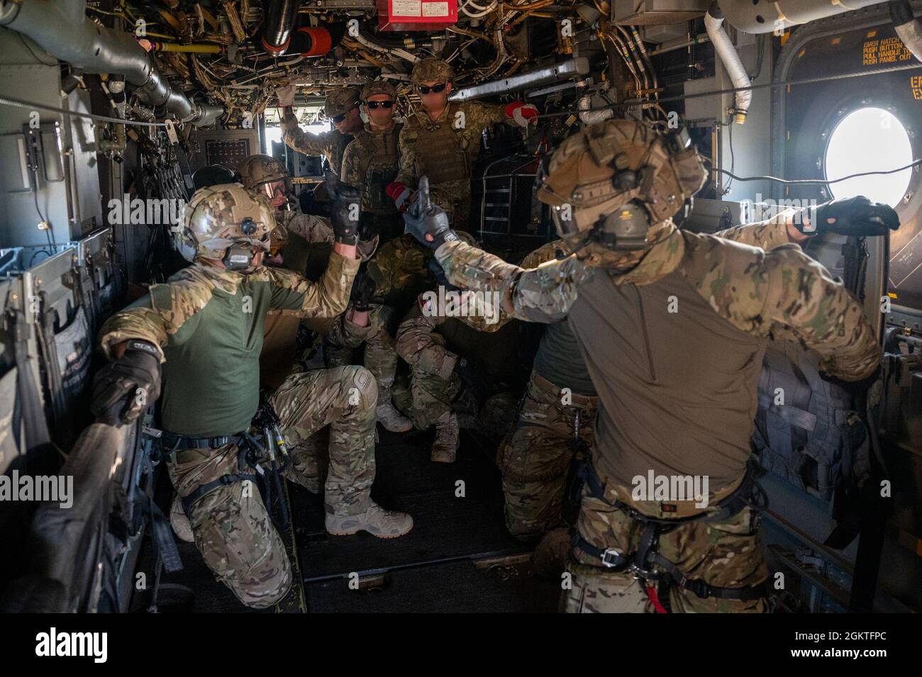 Polish Special Operators signal in preparation to repel from a U.S. Air Force CV-22B Osprey during a fast-rope insertion and extraction training during exercise Sea Breeze 21 at Ochakiv, Ukraine, June 29, 2021. This is the 21st iteration of the exercise which is an annual Ukraine and U.S. co-hosted multinational maritime exercise held in the Black Sea region and is designed to enhance interoperability of participating nations, strengthening maritime security in support of stability within the region. Stock Photo