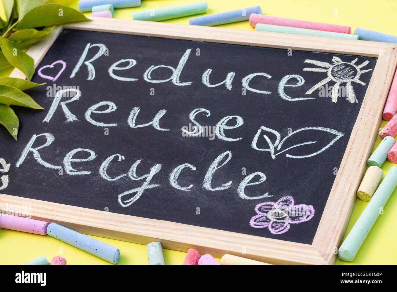 Chalk board Reduse Reuse Recycle sign on a yellow background with green ...