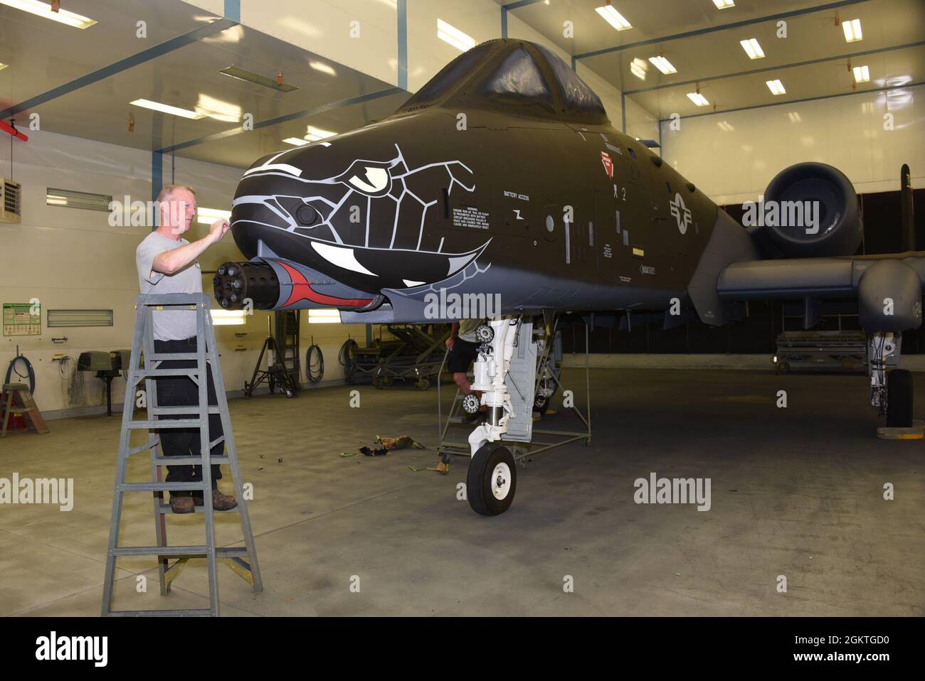Air National Guard Paint Facility Technician, Paul Grigsby Cleans Up Stenciling On The Nose Of A U.s. Air Force A-10 Thunderbolt Ii While In The Paint Booth At The Sioux City, Iowa