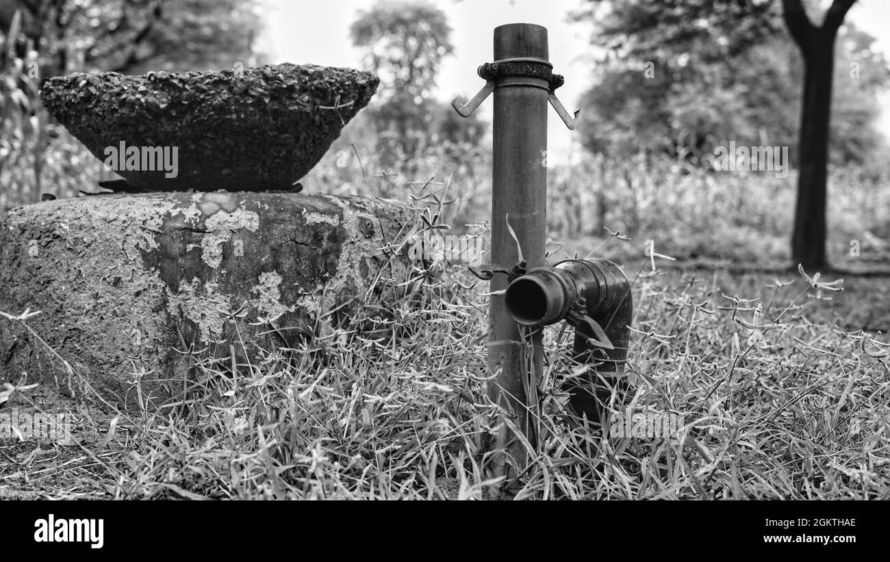 Black and white shot, Plastic pipes for irrigation for Water supply to different different side in the field. Stock Photo