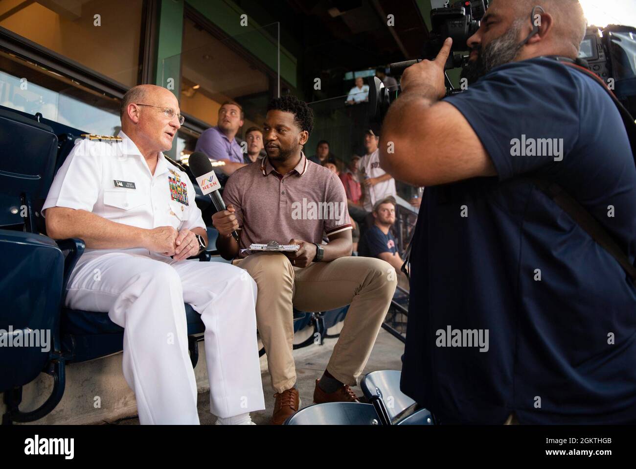 210629-N-BB269-1295 BOSTON (June 29, 2021) Chief of Naval Operations Adm. Mike Gilday speaks in an interview with Northeast Sports Network during a Red Sox baseball game at Fenway Park, Boston. Prior to the game, CNO administered the oath of enlistment to future U.S. Navy Sailors, Strike Fighter Squadron 213 (VFA-213) the Blacklions conducted a fly over, a Navy Band D.C. vocalist sang the national anthem, and the USS Constitution color guard paraded the colors in front of the audience. Stock Photo