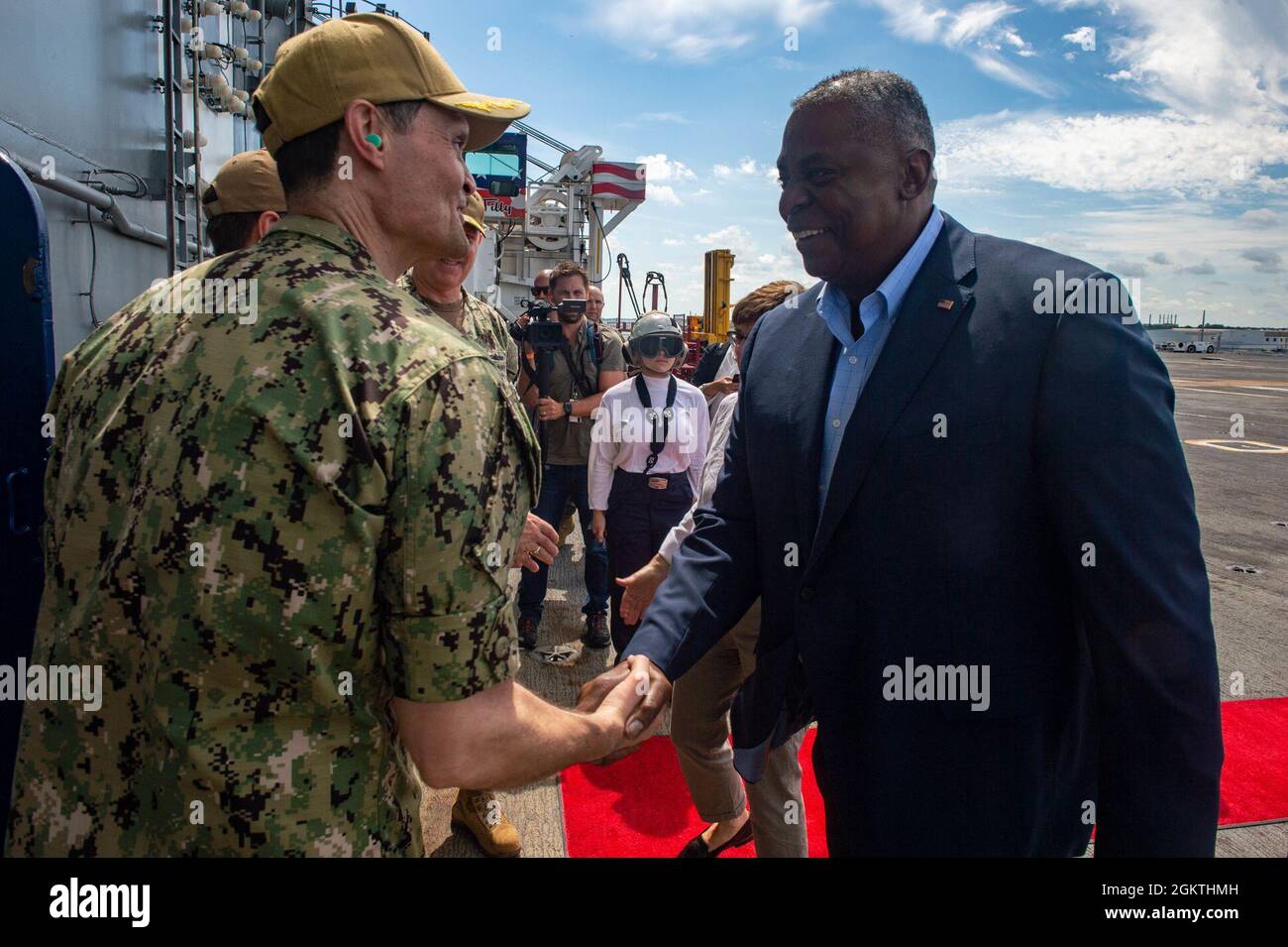 210630-N-IG124-1010 NORFOLK, Va. (June 30, 2021) Secretary of Defense Lloyd J. Austin III is greeted by Capt. Kavon Hakimzadeh, commanding officer of the Nimitz-class aircraft carrier USS Harry S. Truman (CVN 75), on Truman’s flight deck. The purpose of the visit was to engage with military leadership and tour U.S. Navy platforms to showcase Sailors and the credible firepower the Navy contributes to global stability and prosperity. USS Harry S. Truman is home-ported in Naval Station Norfolk and is the flagship of Carrier Strike Group 8. Stock Photo