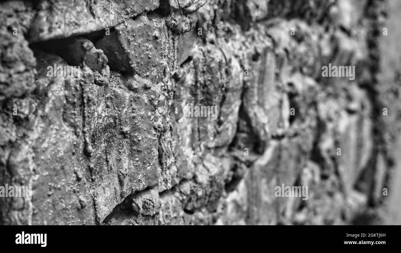Black and white shot, Old building wall made by concrete and bricks. Selective focus Stock Photo
