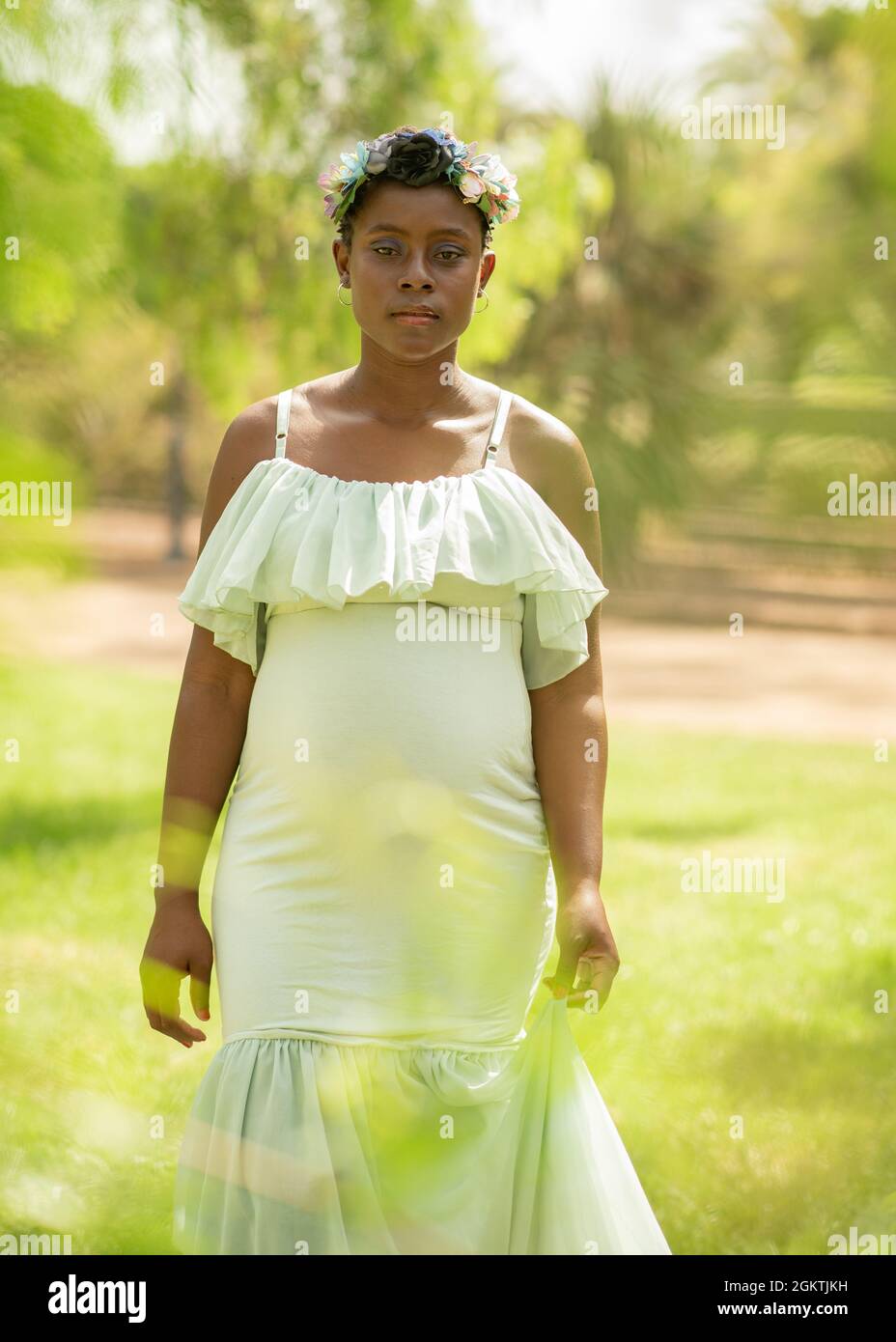 Pregnant African American woman in white dress Stock Photo