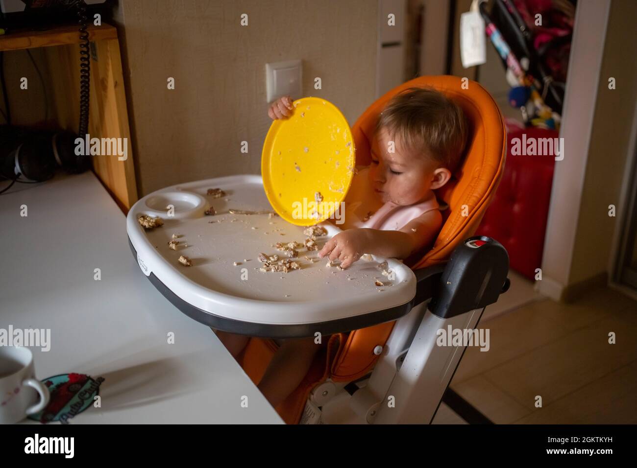 toddler baby eating dirty in the highchair at home Stock Photo Alamy