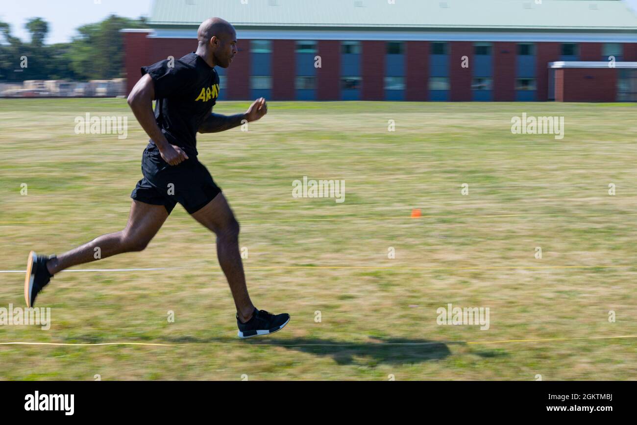 Staff Sgt. Ian Brown, an automated logistical specialist assigned to the 6th Recruiting and Retention Battalion, Connecticut Army National Guard, runs while conducting the sprint-drag-carry portion of the Army Combat Fitness Test at Camp Nett, Niantic, Connecticut, June 30, 2021. During the sprint-drag-carry soldiers must complete five 50 meter shuttles, including weighted shuttle carries in three minutes or less. Stock Photo