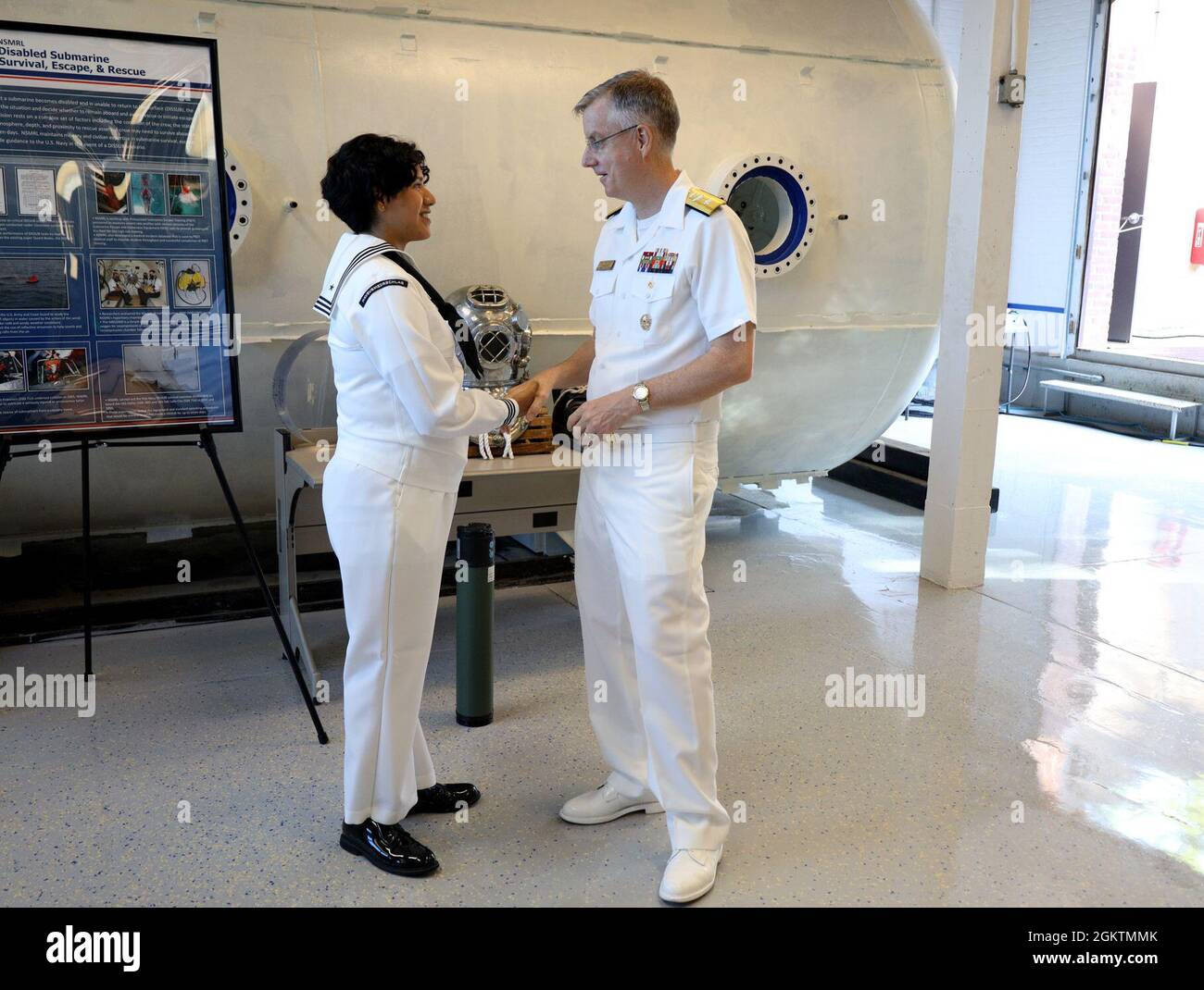 Rear Adm. Tim er, Commander, Naval Medical Forces Pacific, presents a coin to Hospital