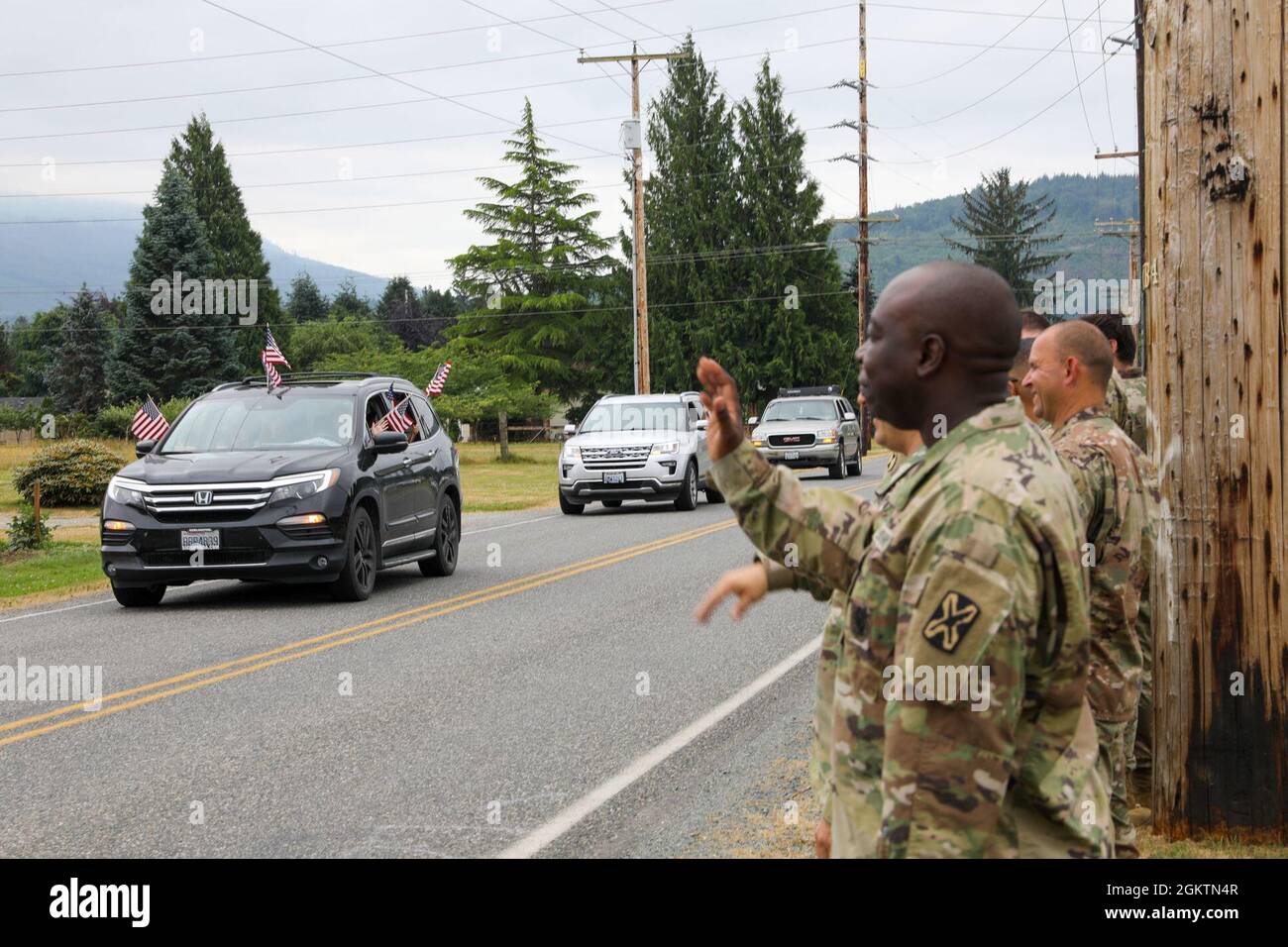 SedroWoolley residents drive their vehicles past the Helping Hands
