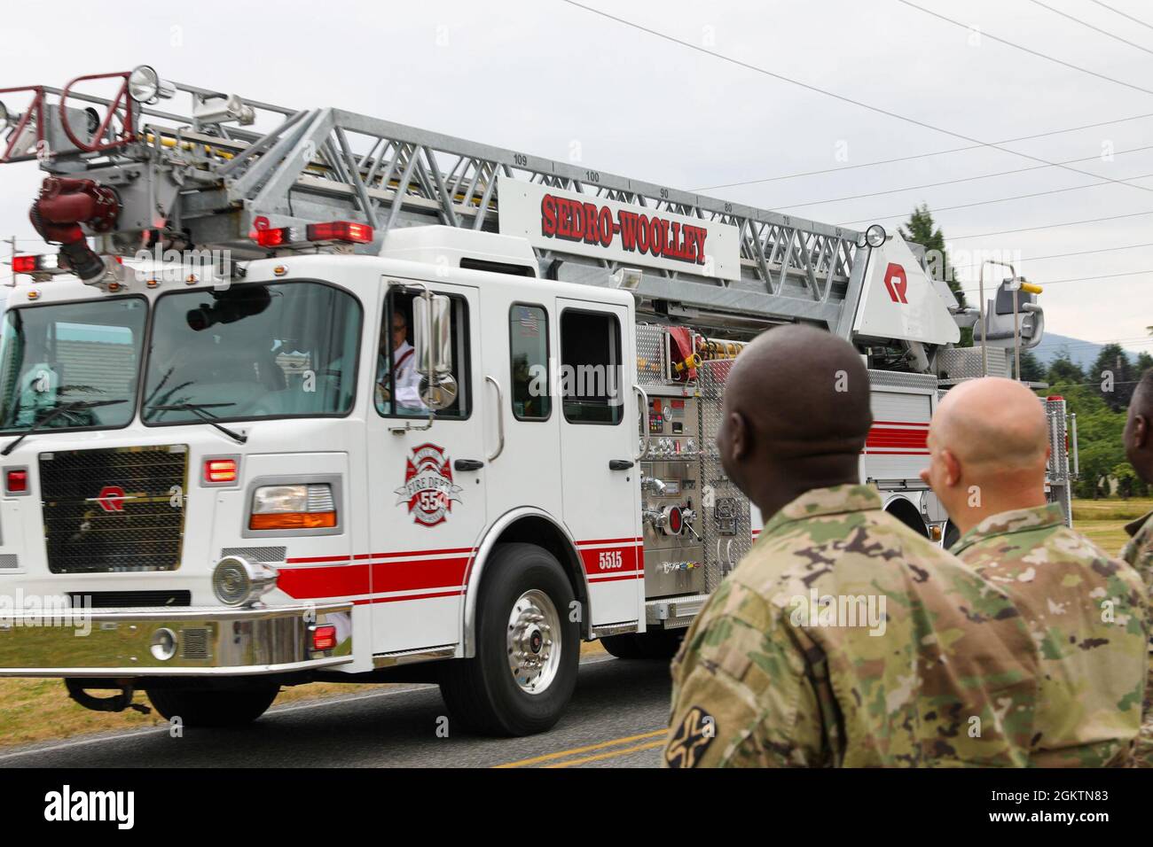 An engine from the SedroWoolley Fire Department drives by the Helping