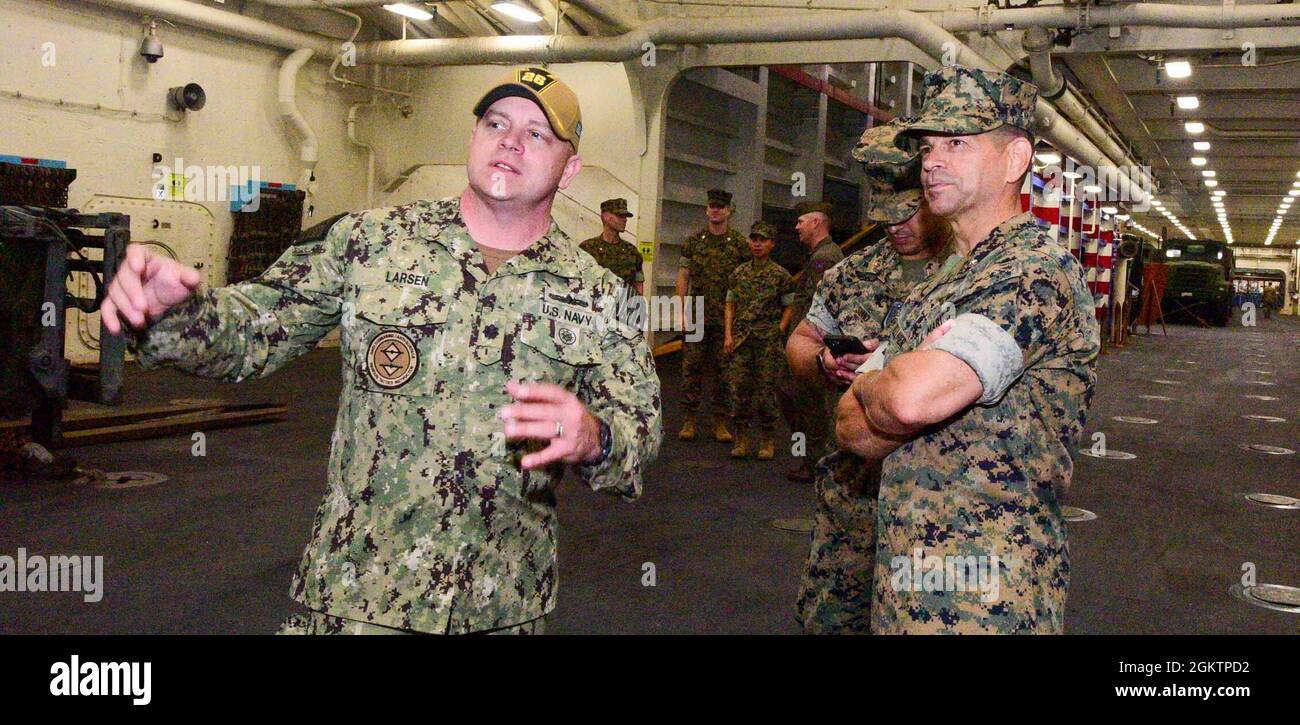 210701-N-MT581-1073    PACIFIC OCEAN (July 1, 2021) Cmdr. Jayson Larsen, from Las Vegas executive officer aboard amphibious transport dock ship USS John P. Murtha (LPD 26), left, gives Brig. Gen. John F. Kelliher III, from Hanson, Mass., deputy commanding general, 1st Marine Expeditionary Force, center, a ship tour, July 1. John P. Murtha is homeported at Naval Base San Diego. Stock Photo